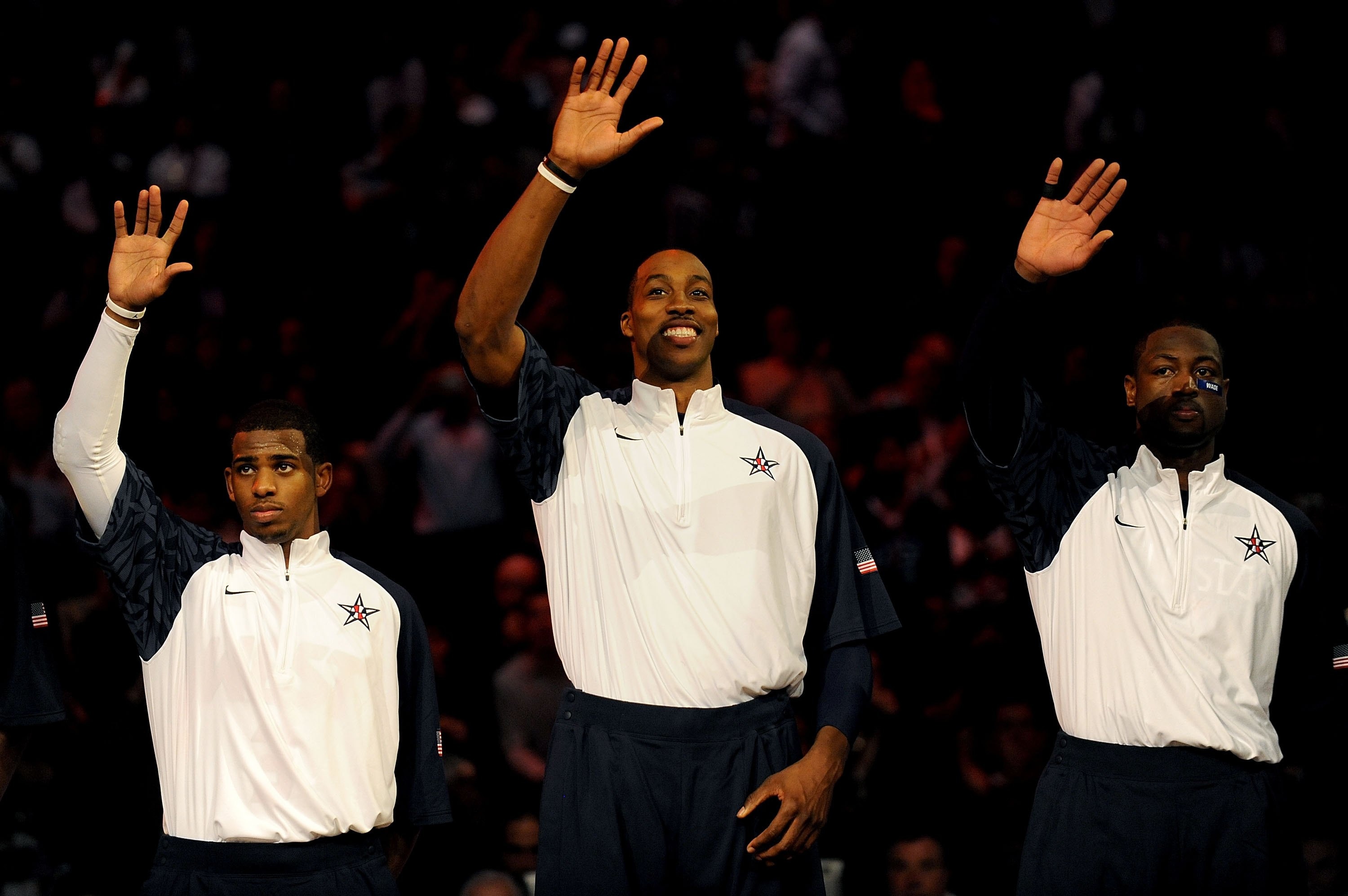 PHOENIX - FEBRUARY 15:  (L-R) Chris Paul, Dwight Howard and Dwyane Wade, members of the men's gold medal winning USA Olympic basketball teams, wave to the crowd during half time of the 58th NBA All-Star Game, part of 2009 NBA All-Star Weekend at US Airway