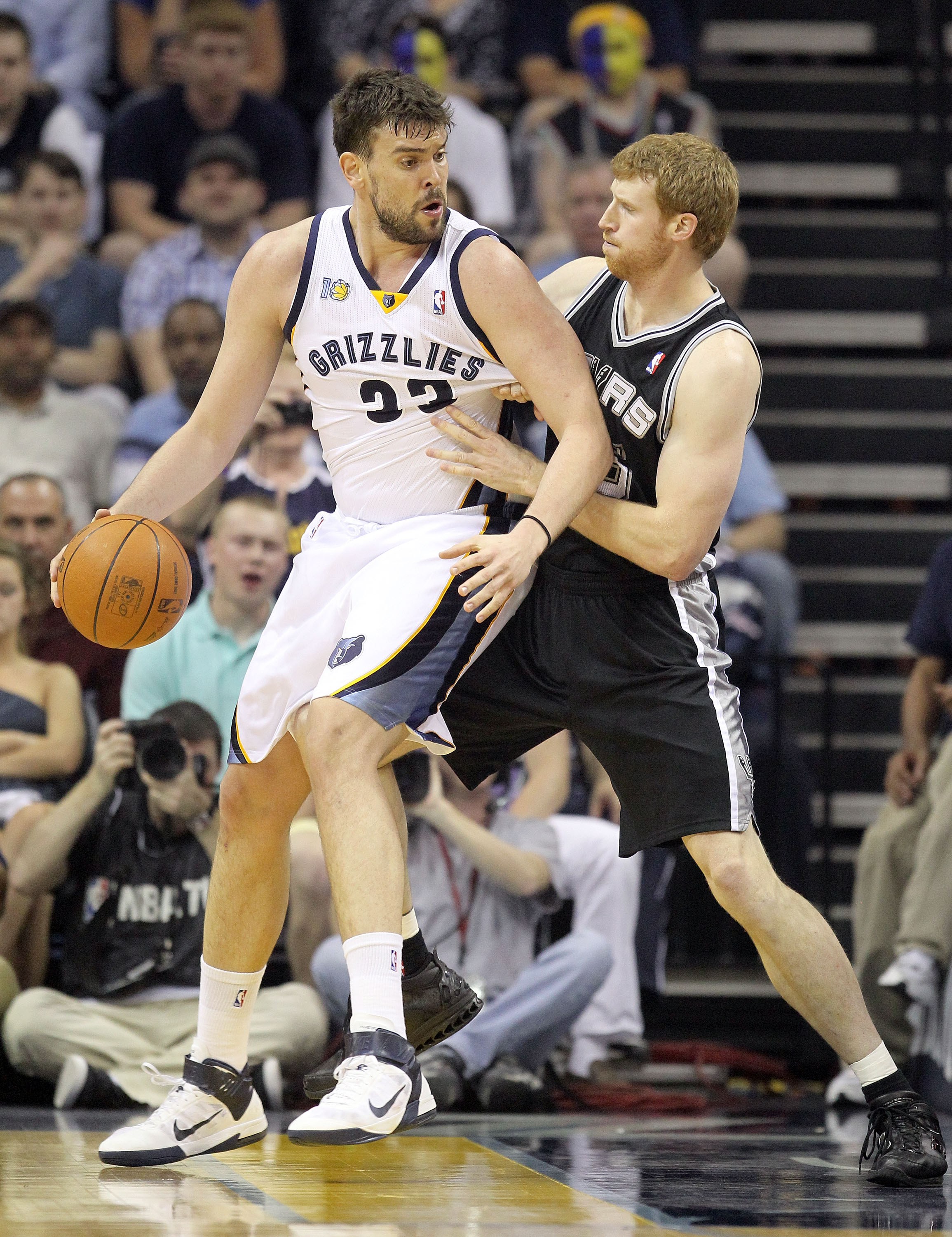 MEMPHIS, TN - APRIL 23:  Marc Gasol #33 of the  Memphis Grizzles dribbles the ball while defended by Matt Bonner #15 of the San Antonio Spurs in Game three of the Western Conference Quarterfinals in the 2011 NBA Playoffs at FedExForum on April 23, 2011 in