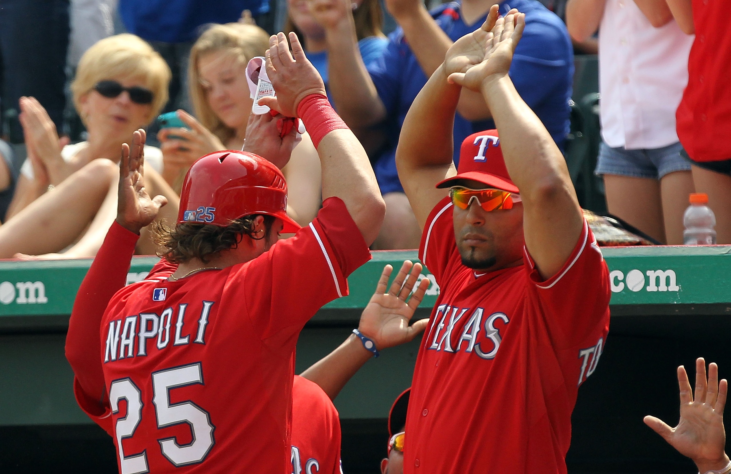 ARLINGTON, TX - APRIL 24:  Mike Napoli #25 of the Texas Rangers celebrates a run with Yorvit Torrealba #8 against the Kansas City Royals in the 6th inning at Rangers Ballpark in Arlington on April 24, 2011 in Arlington, Texas.  (Photo by Ronald Martinez/G