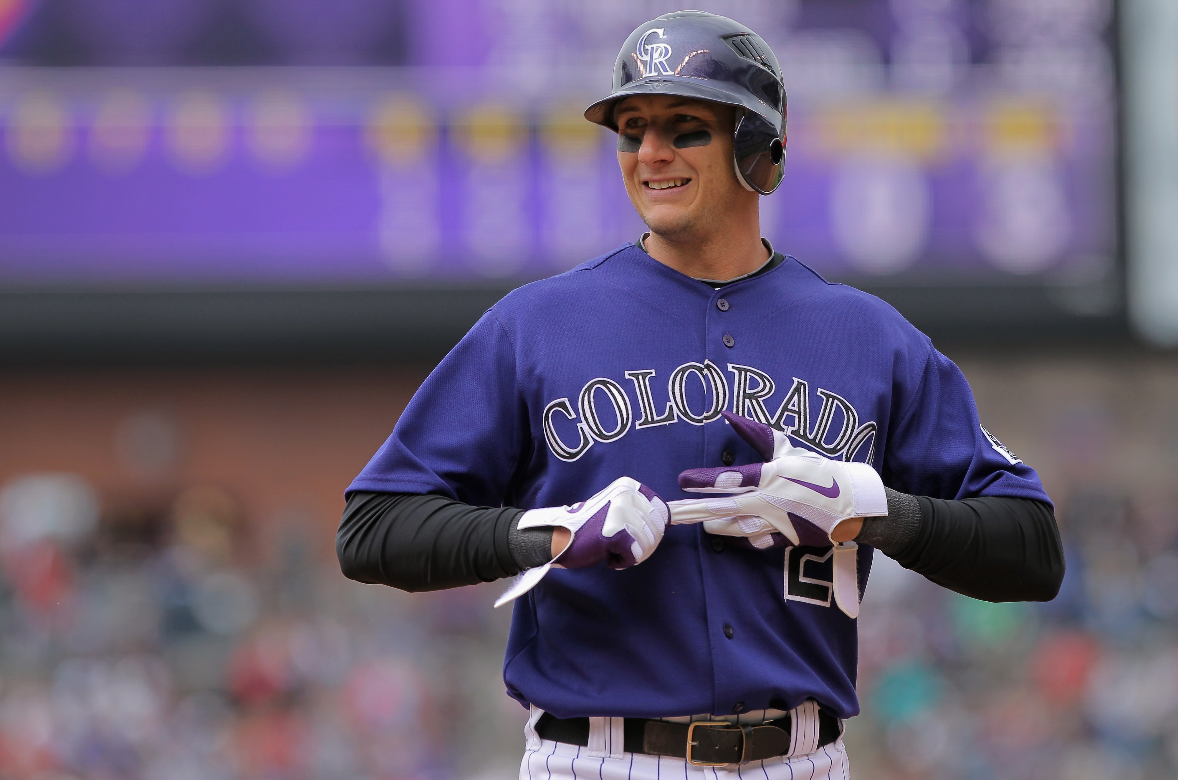 DENVER, CO - APRIL 20:  Shortstop Troy Tulowitzki #2 of the Colorado Rockies removes his batting gloves after taking an at bat against the San Francisco Giants at Coors Field on April 20, 2011 in Denver, Colorado.  (Photo by Doug Pensinger/Getty Images)
