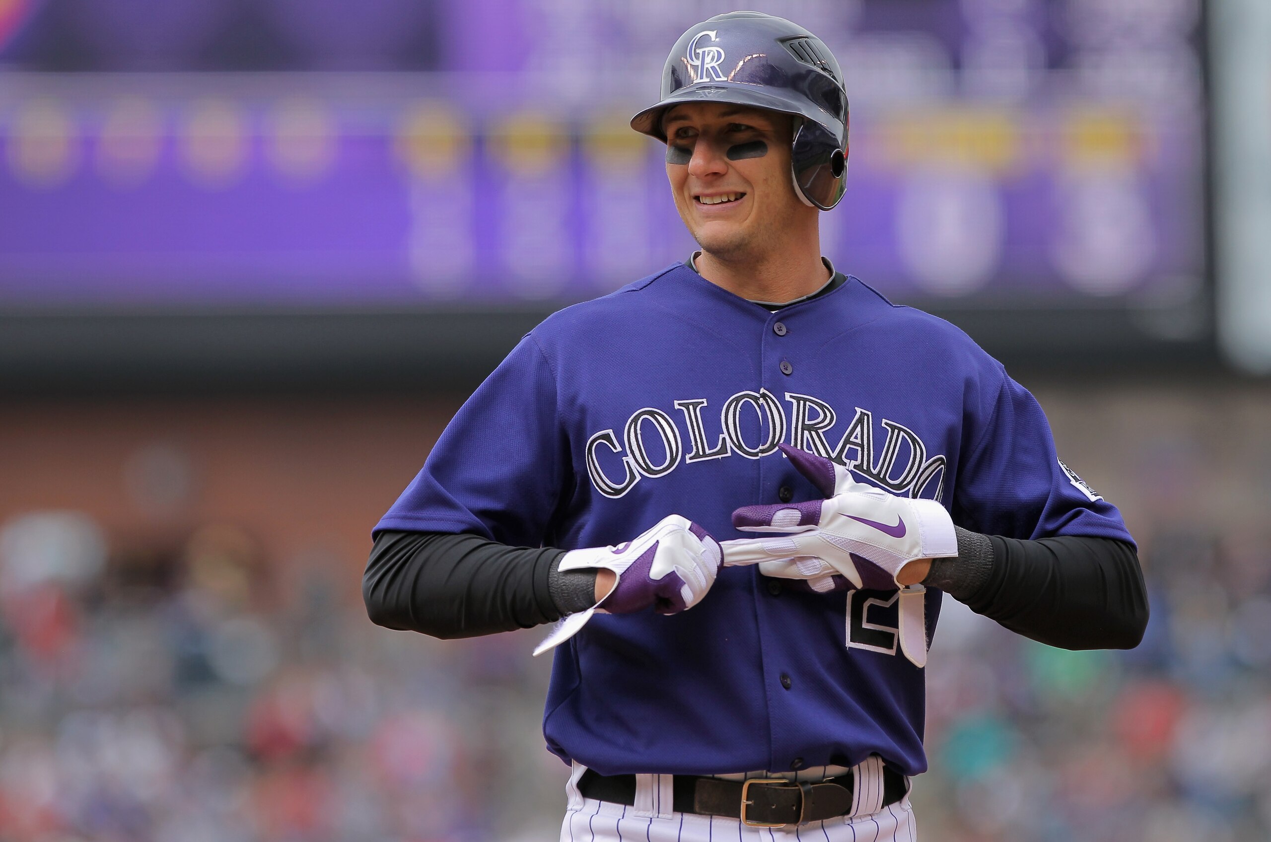 DENVER, CO - APRIL 20:  Shortstop Troy Tulowitzki #2 of the Colorado Rockies removes his batting gloves after taking an at bat against the San Francisco Giants at Coors Field on April 20, 2011 in Denver, Colorado.  (Photo by Doug Pensinger/Getty Images)
