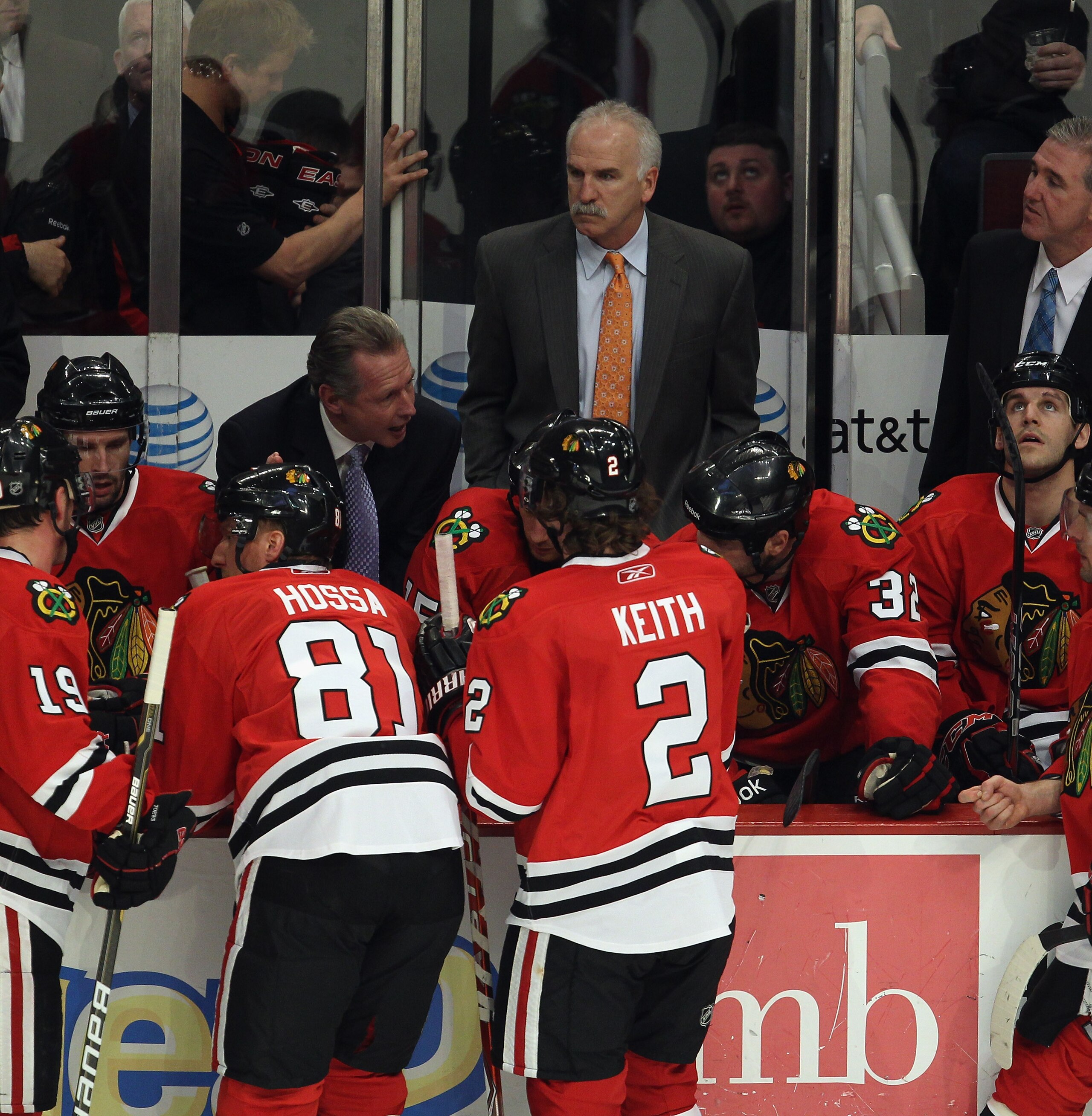 CHICAGO, IL - APRIL 17: Head coach Joel Quenneville (center) of the Chicago Blackhawks listens as assistant coaches talk with players against the Vancouver Canucks in Game Three of the Western Conference Quarterfinals during the 2011 NHL Stanley Cup Playo