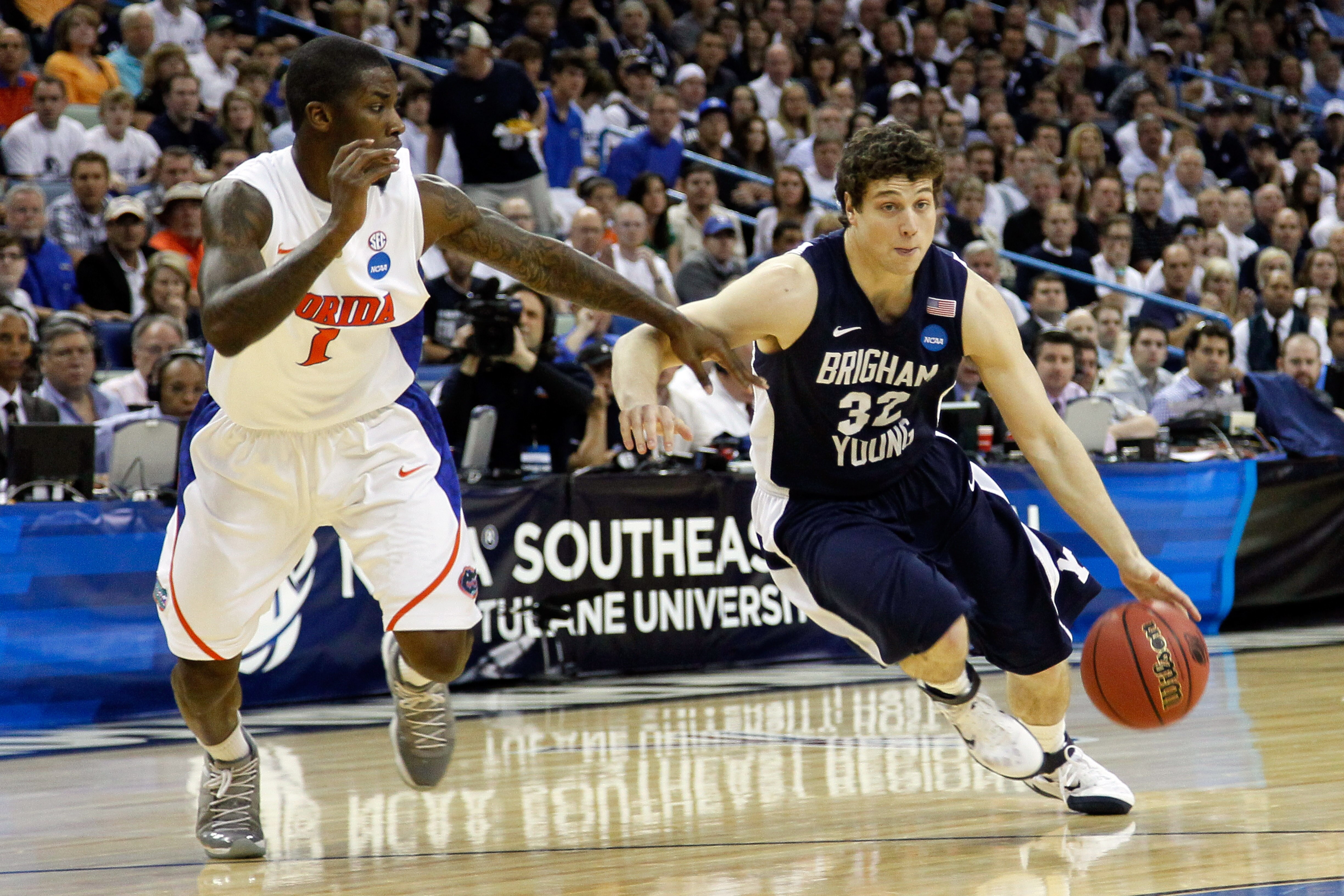 NEW ORLEANS, LA - MARCH 24:  Jimmer Fredette #32 of the Brigham Young Cougars drives against Kenny Boynton #1 of the Florida Gators during the Southeast regional of the 2011 NCAA men's basketball tournament at New Orleans Arena on March 24, 2011 in New Or
