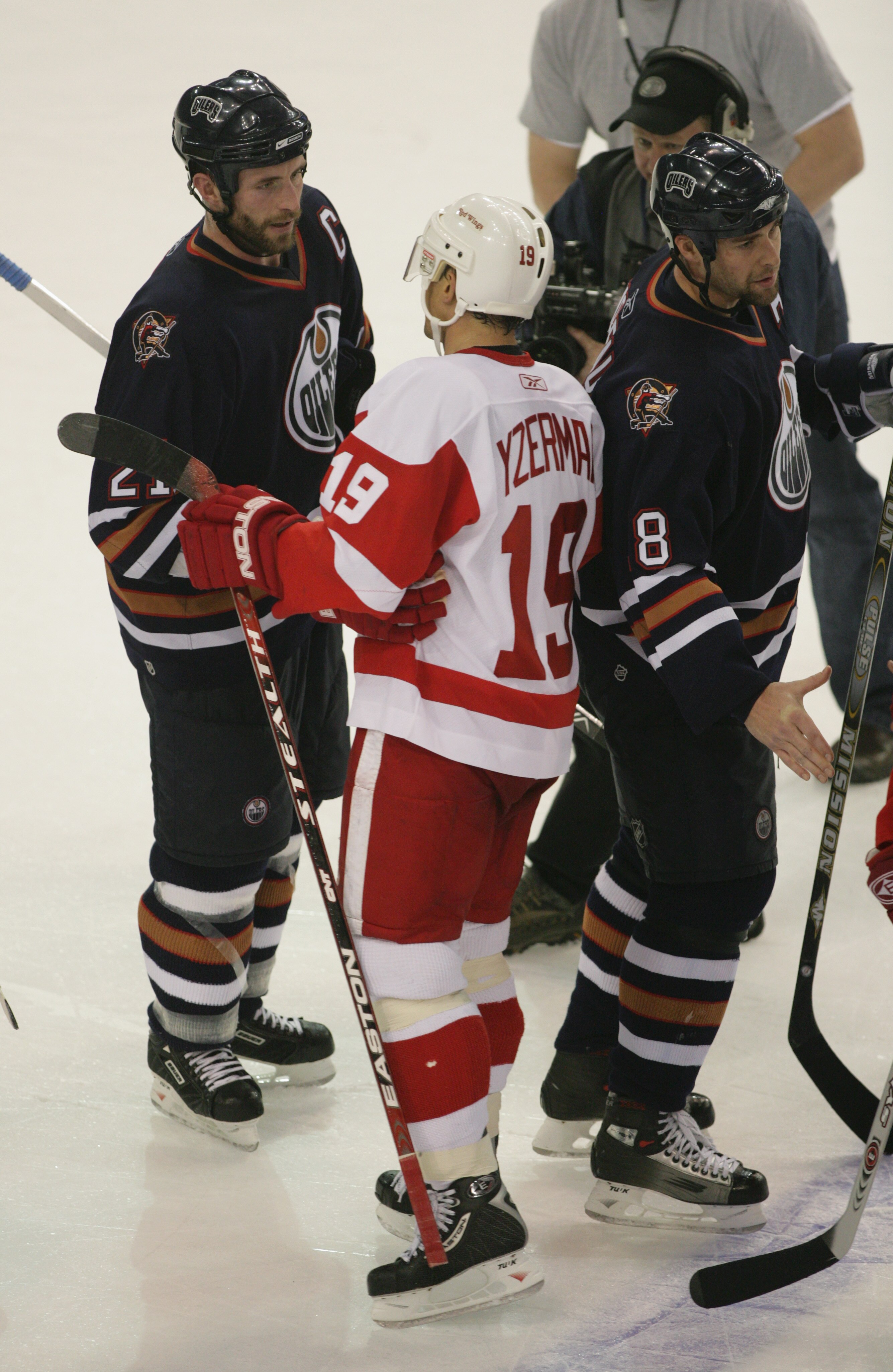 EDMONTON - May 1:  A dejected Steve Yzerman #19 of the Detroit Red Wings congratulates and shakes hands with Jason Smith #21 of the Edmonton Oilers after being eliminated in game six of the Western Conference Quarterfinals during the NHL Stanley Cup Playo