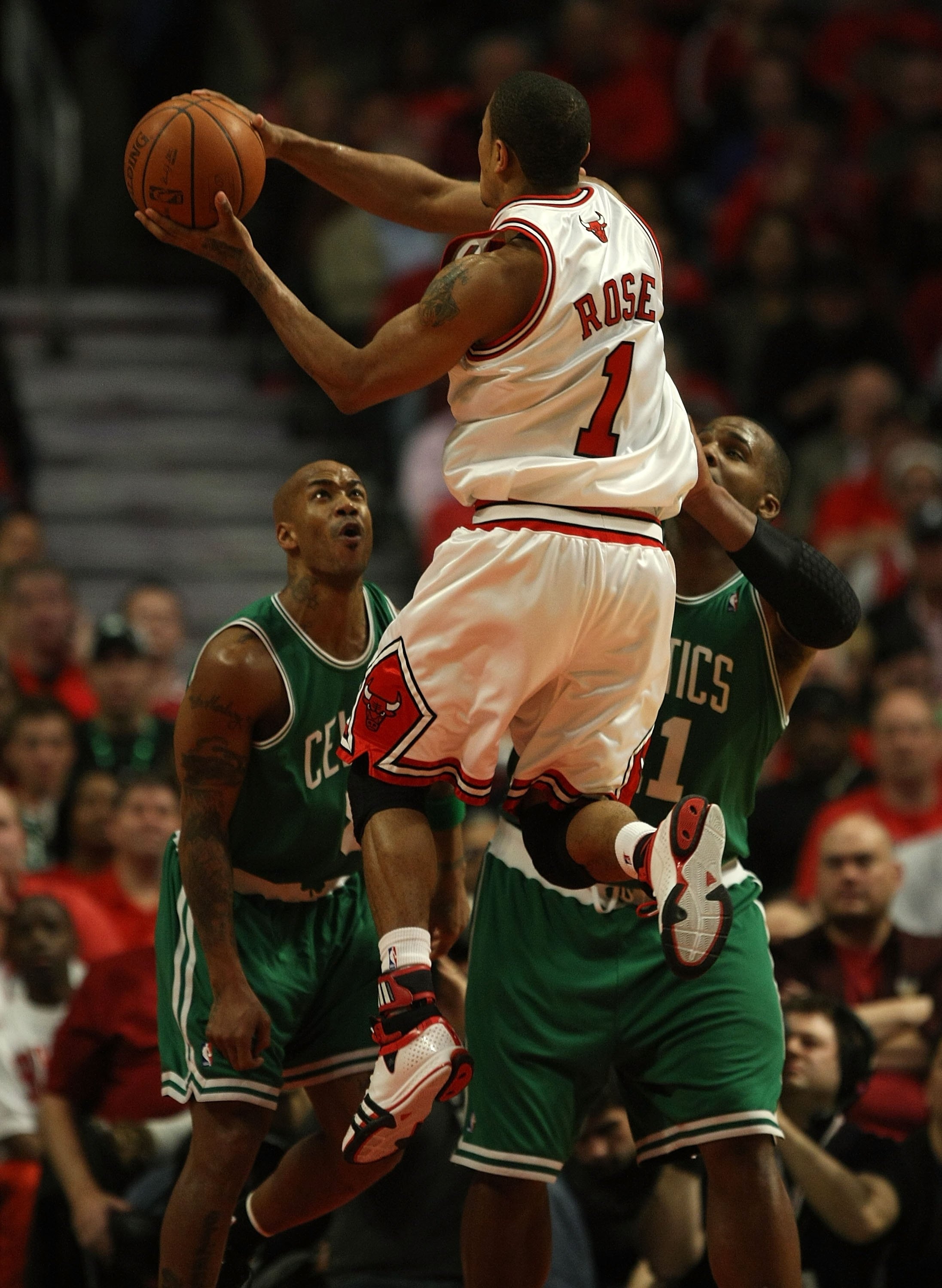 CHICAGO - APRIL 23: Derrick Rose #1 of the Chicago Bulls puts up a shot over Stephon Marbury #8 and Glen Davis #11 of the Boston Celtics in Game Three of the Eastern Conference Quarterfinals during the 2009 NBA Playoffs at the United Center on April 23, 2