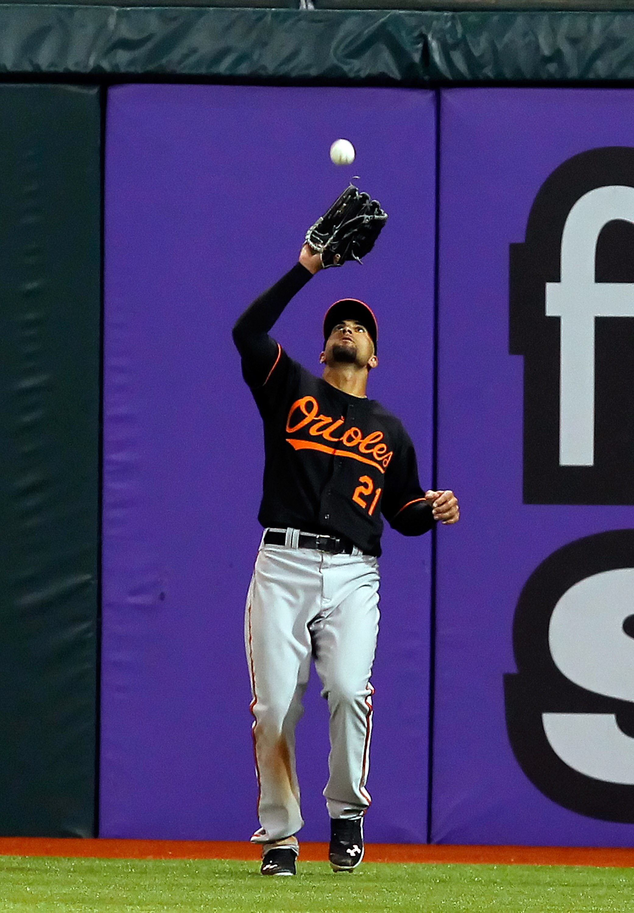 ST. PETERSBURG, FL - APRIL 01:  Outfielder Nick Markakis #21 of the Baltimore Orioles catches a fly ball against the Tampa Bay Rays during the Opening Day game at Tropicana Field on April 1, 2011 in St. Petersburg, Florida.  (Photo by J. Meric/Getty Image