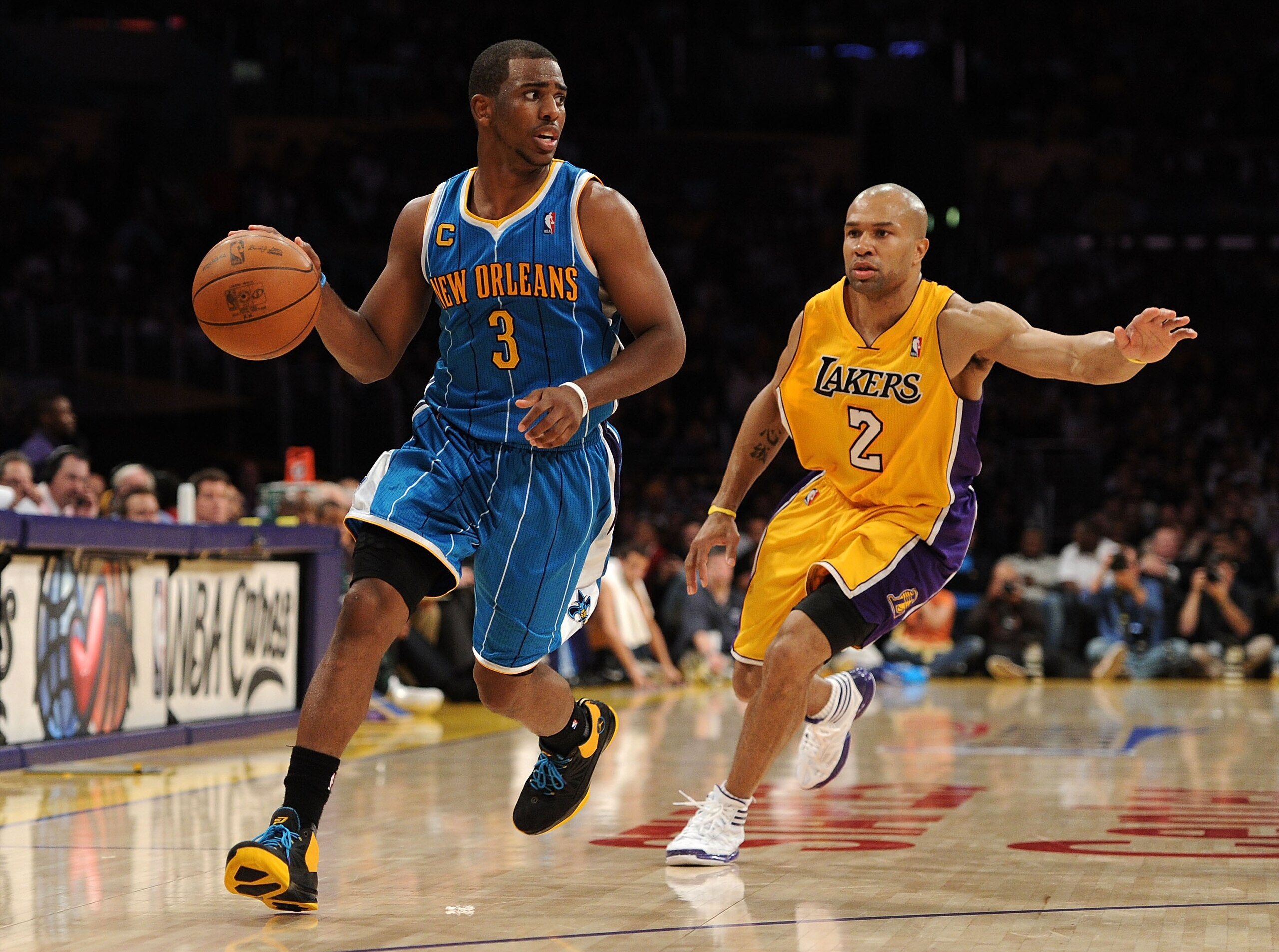 LOS ANGELES, CA - APRIL 20:  Chris Paul #3 of the New Orleans Hornets drives on Derek Fisher #2 of the Los Angeles Lakers in Game Two of the Western Conference Quarterfinals in the 2011 NBA Playoffs on April 20, 2011 at Staples Center in Los Angeles, Cali