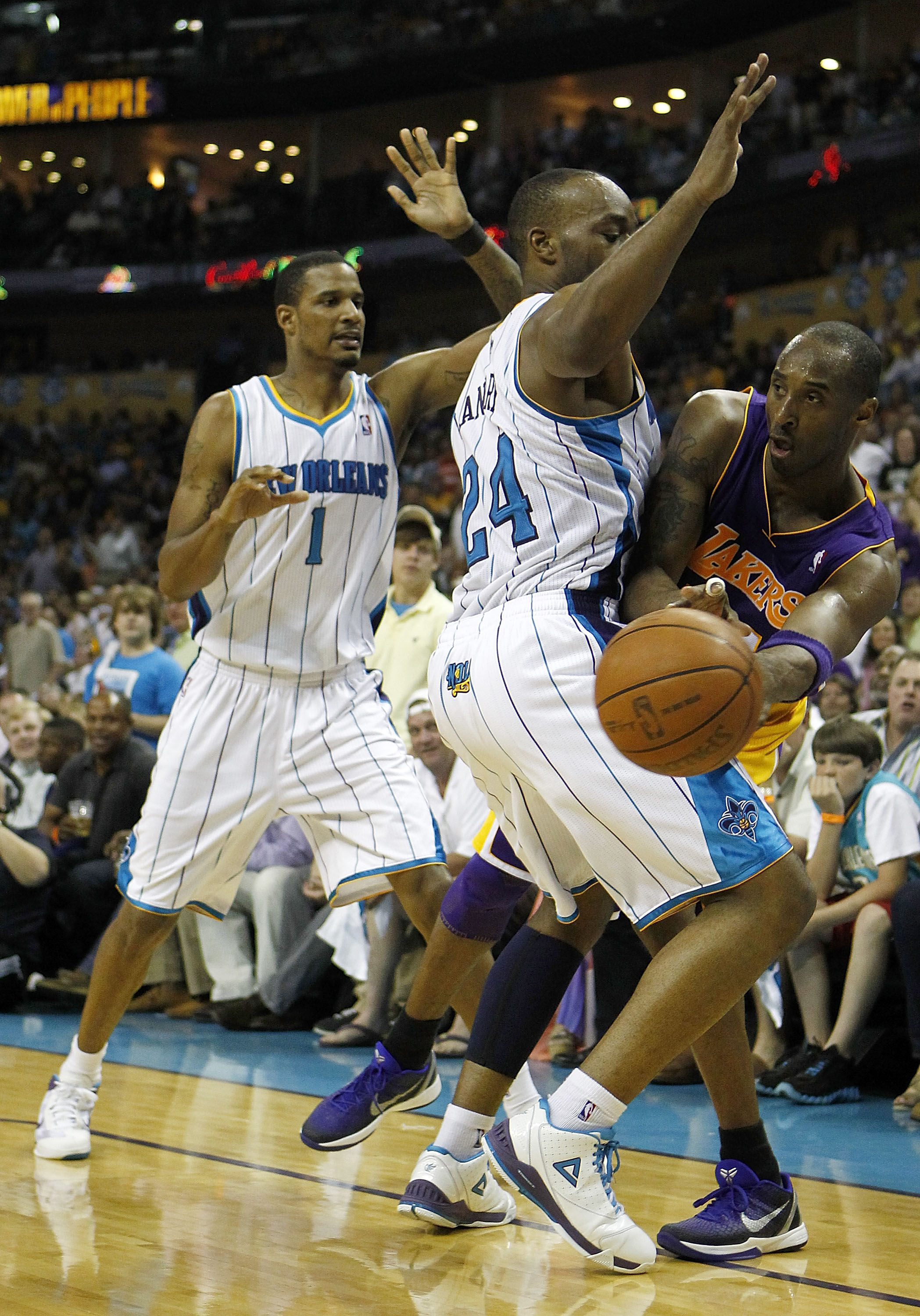 NEW ORLEANS - APRIL 24:  Kobe Bryant #24 of the Los Angeles Lakers tries to pass around Carl Landry #24 of the New Orleans Hornets  in Game Four of the Western Conference Quarterfinals in the 2011 NBA Playoffs at New Orleans Arena on April 24, 2011 in New