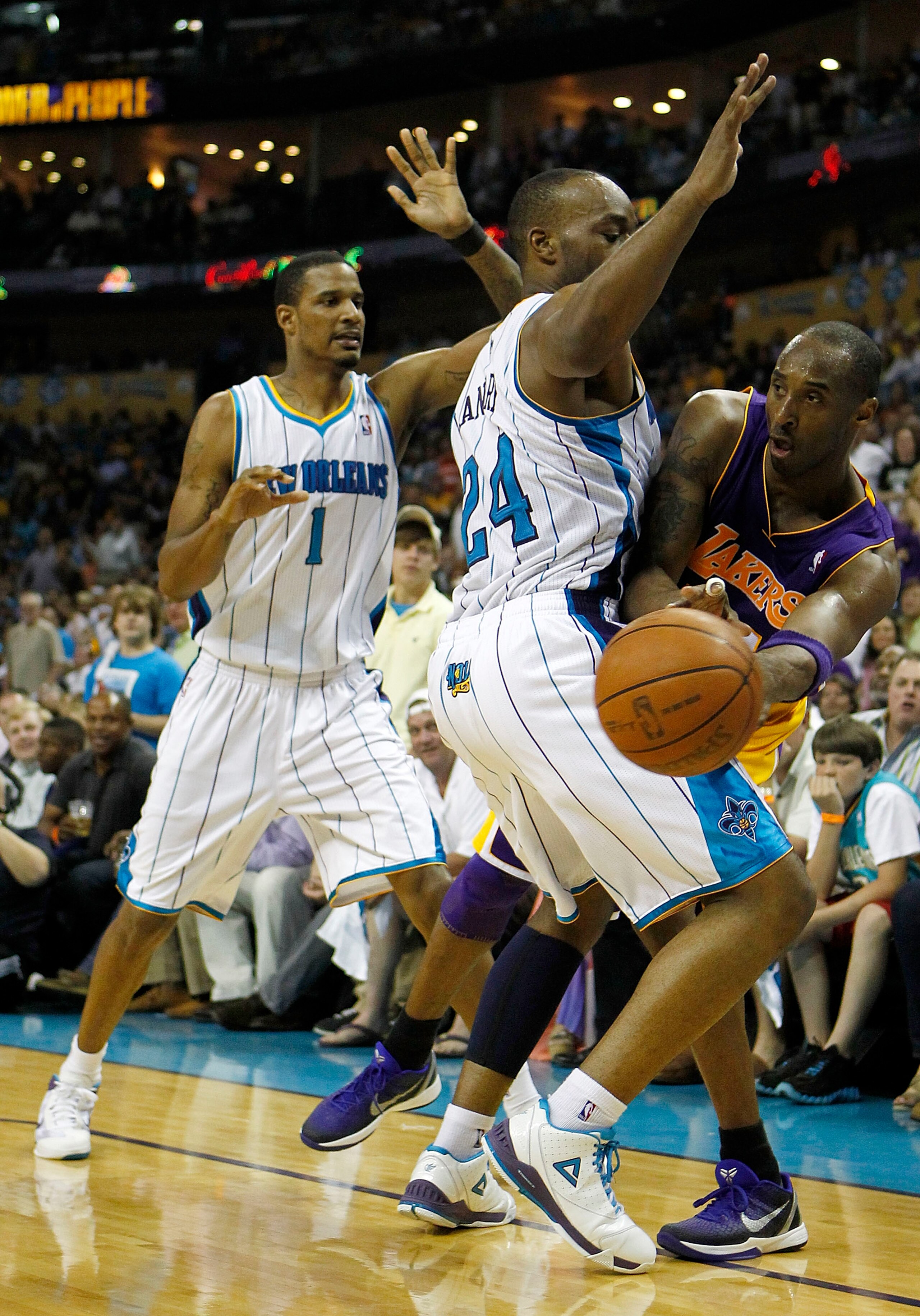 NEW ORLEANS - APRIL 24:  Kobe Bryant #24 of the Los Angeles Lakers tries to pass around Carl Landry #24 of the New Orleans Hornets  in Game Four of the Western Conference Quarterfinals in the 2011 NBA Playoffs at New Orleans Arena on April 24, 2011 in New