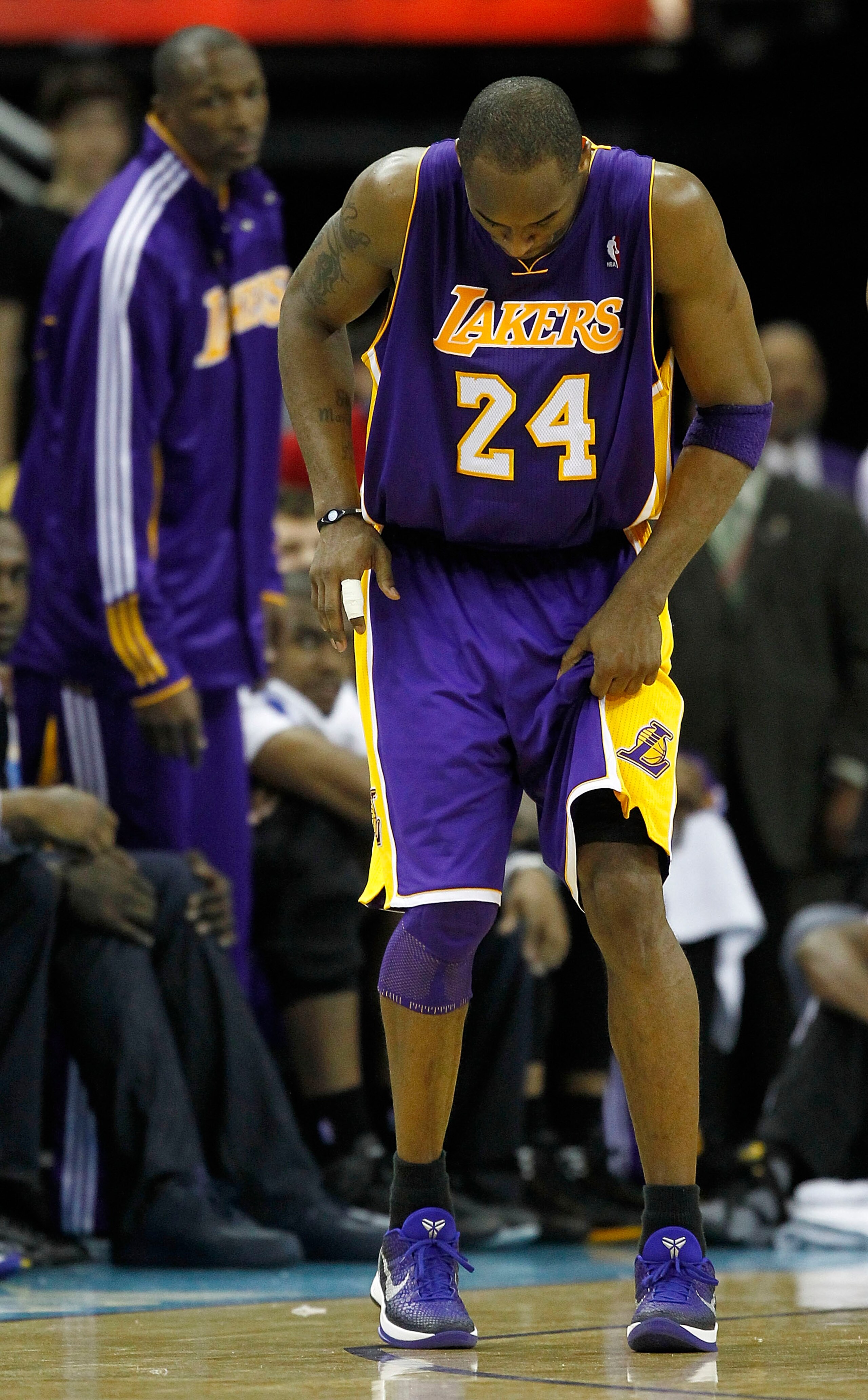 NEW ORLEANS - APRIL 24:  Kobe Bryant #24 of the Los Angeles Lakers limps onto the court against the New Orleans Hornets in Game Four of the Western Conference Quarterfinals in the 2011 NBA Playoffs at New Orleans Arena on April 24, 2011 in New Orleans, Lo