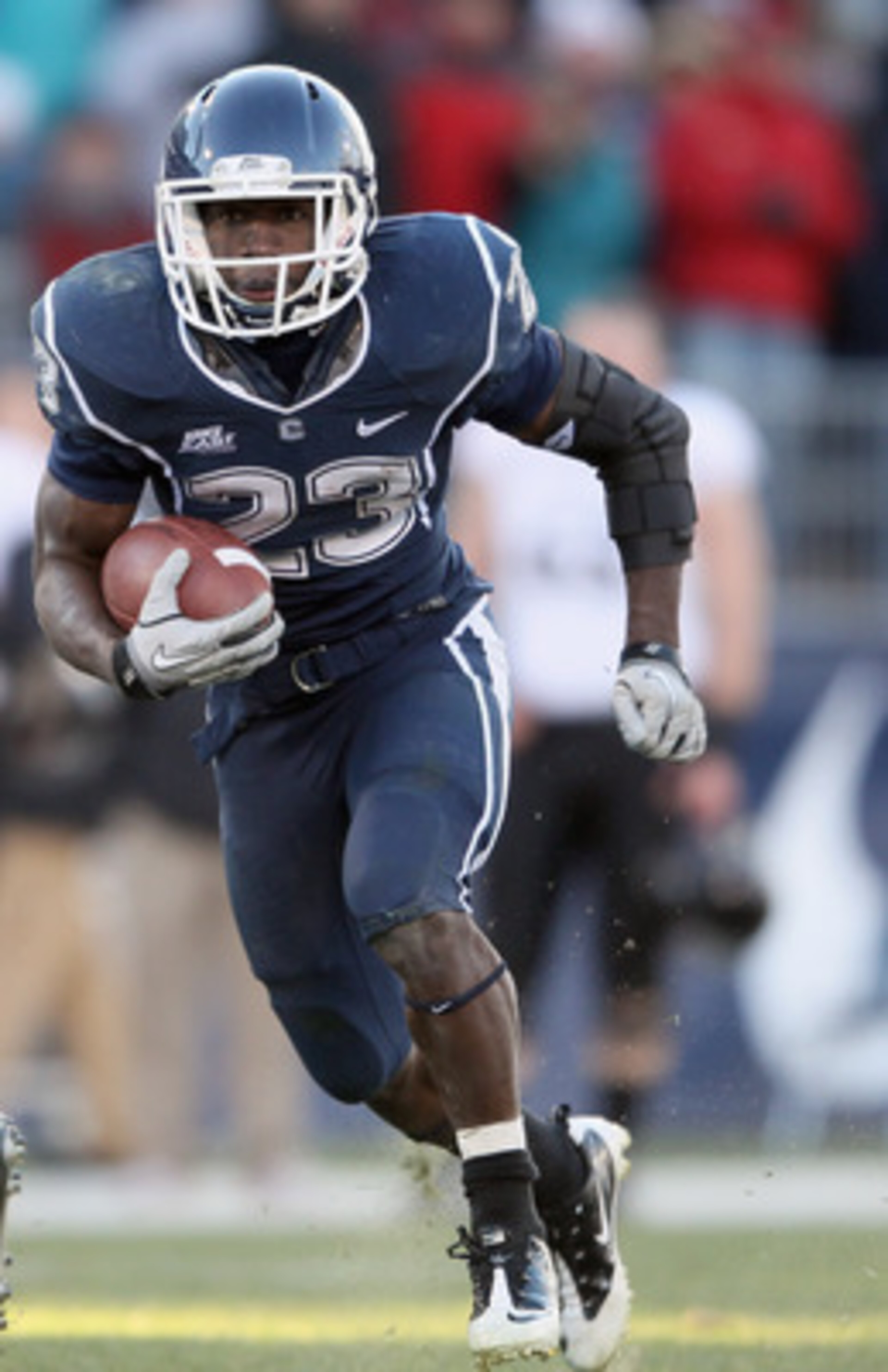 EAST HARTFORD, CT - NOVEMBER 27: Jordan Todman #23 of the Connecticut Huskies carries the ball around the Cincinnati Bearcats defense on November 27, 2010 at Rentschler Field in East Hartford, Connecticut. The Huskies defeated the Bearcats 38-17. (Photo EAST HARTFORD, CT - NOVEMBER 27: Jordan Todman #23 of the Connecticut Huskies carries the ball around the Cincinnati Bearcats defense on November 27, 2010 at Rentschler Field in East Hartford, Connecticut. The Huskies defeated the Bearcats 38-17. (Photo