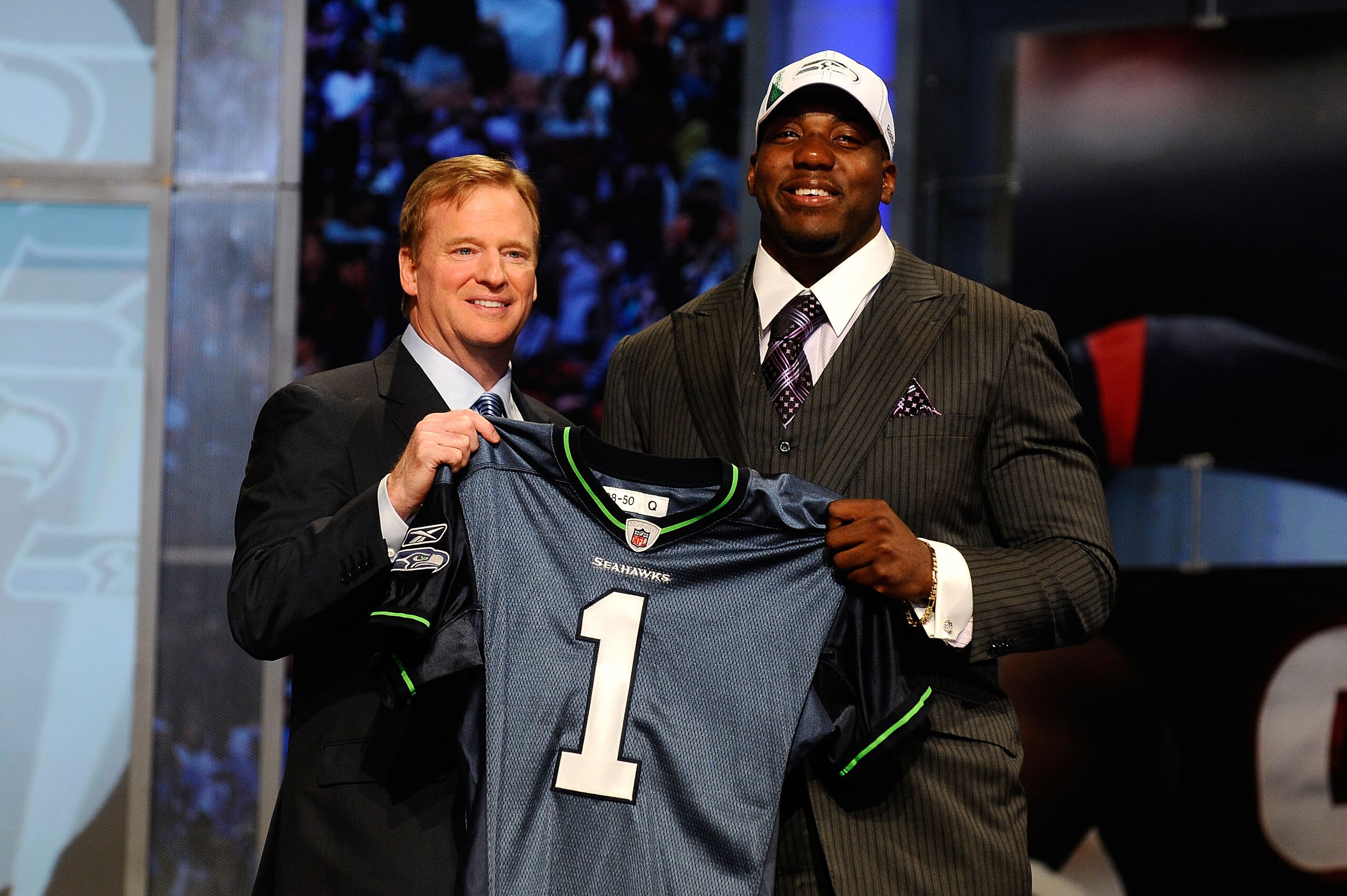 NEW YORK - APRIL 22:  Russell Okung from the Oklahoma State Cowboys poses with NFL Commissioner Roger Goodell (L) as they hold a Seattle Seahawks jersey after he was selected #6 overall by the Seahawks in the first round during the 2010 NFL Draft at Radio