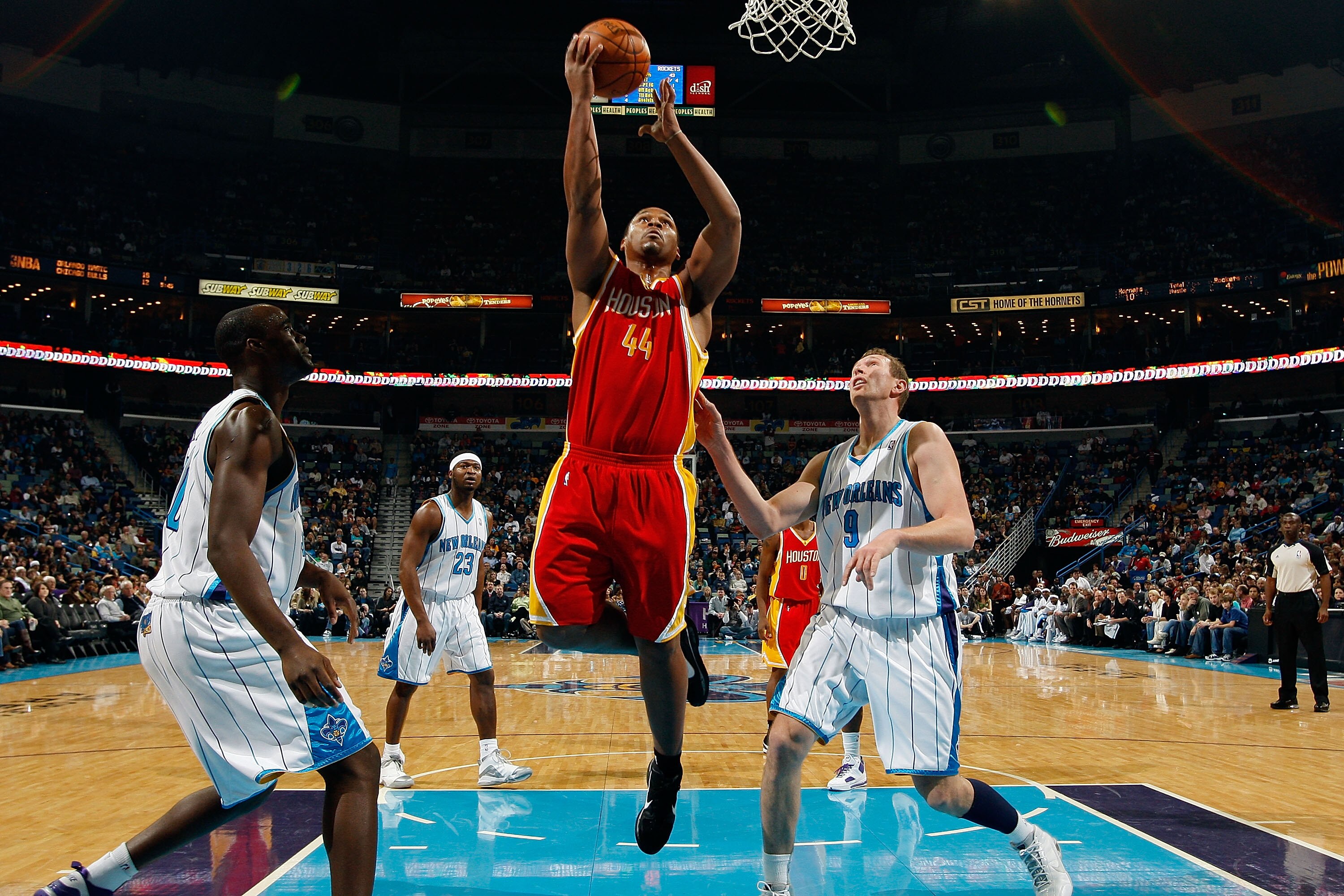 NEW ORLEANS, LA - JANUARY 02:  Chuck Hayes #44  of the Houston Rockets makes a shot over Darius Songaila #9 and Emeka Okafor #50 of the New Orleans Hornets at the New Orleans Arena on January 2, 2010 in New Orleans, Louisiana.  NOTE TO USER: User expressl