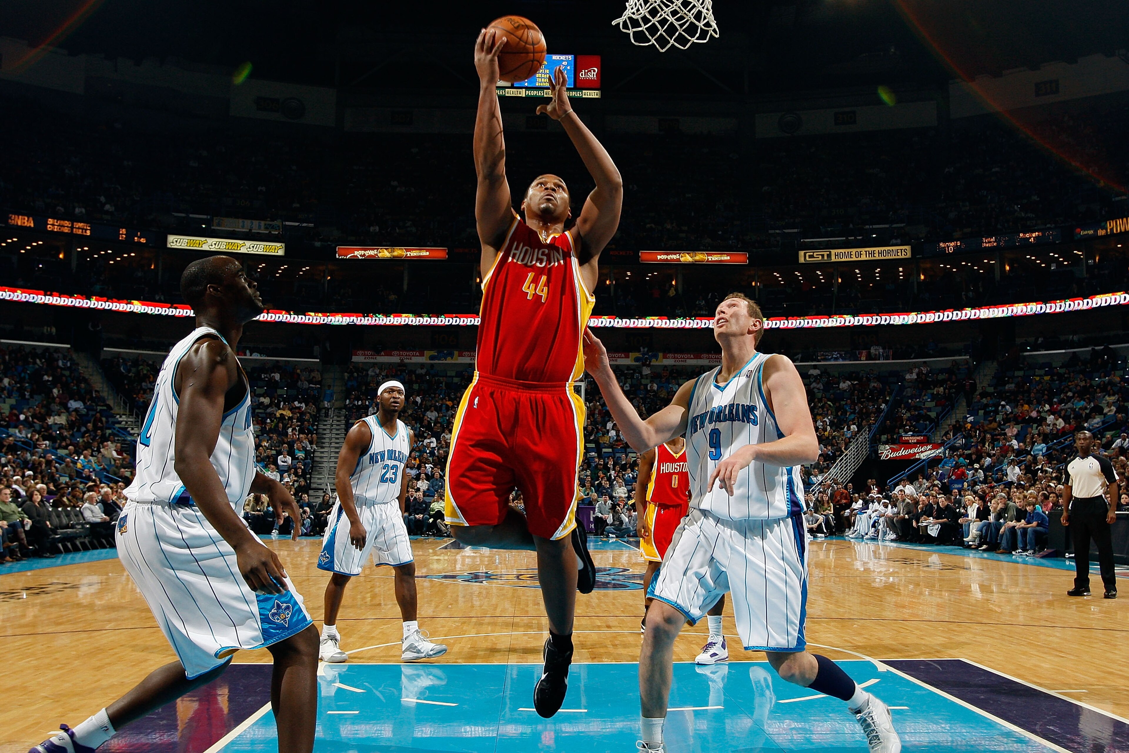 NEW ORLEANS, LA - JANUARY 02:  Chuck Hayes #44  of the Houston Rockets makes a shot over Darius Songaila #9 and Emeka Okafor #50 of the New Orleans Hornets at the New Orleans Arena on January 2, 2010 in New Orleans, Louisiana.  NOTE TO USER: User expressl