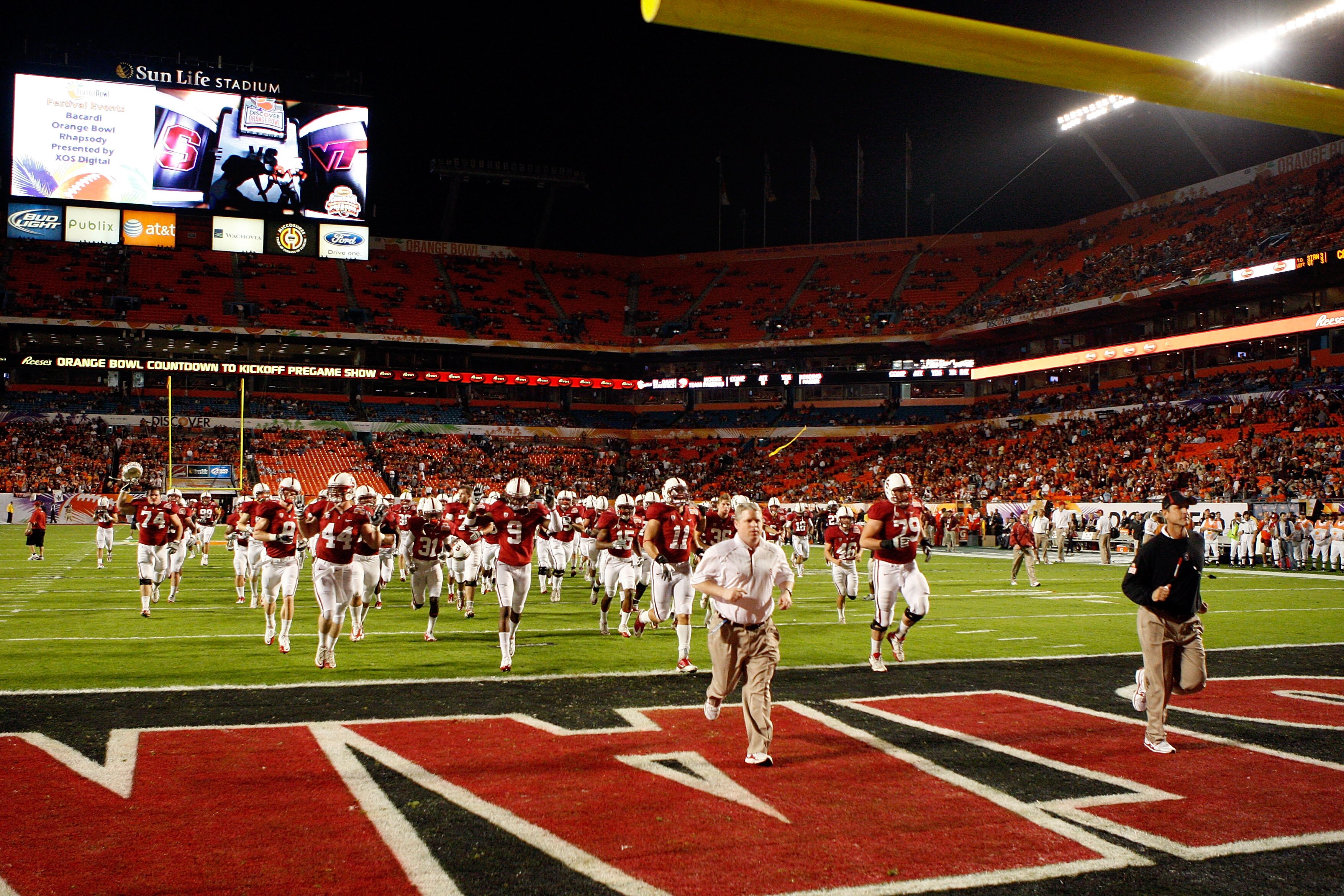 MIAMI, FL - JANUARY 03:  Head coach Jim Harbaugh of the Stanford Cardinal leads his players off the field and back to the locker room following warm ups against the Virginia Tech Hokies during the 2011 Discover Orange Bowl at Sun Life Stadium on January 3