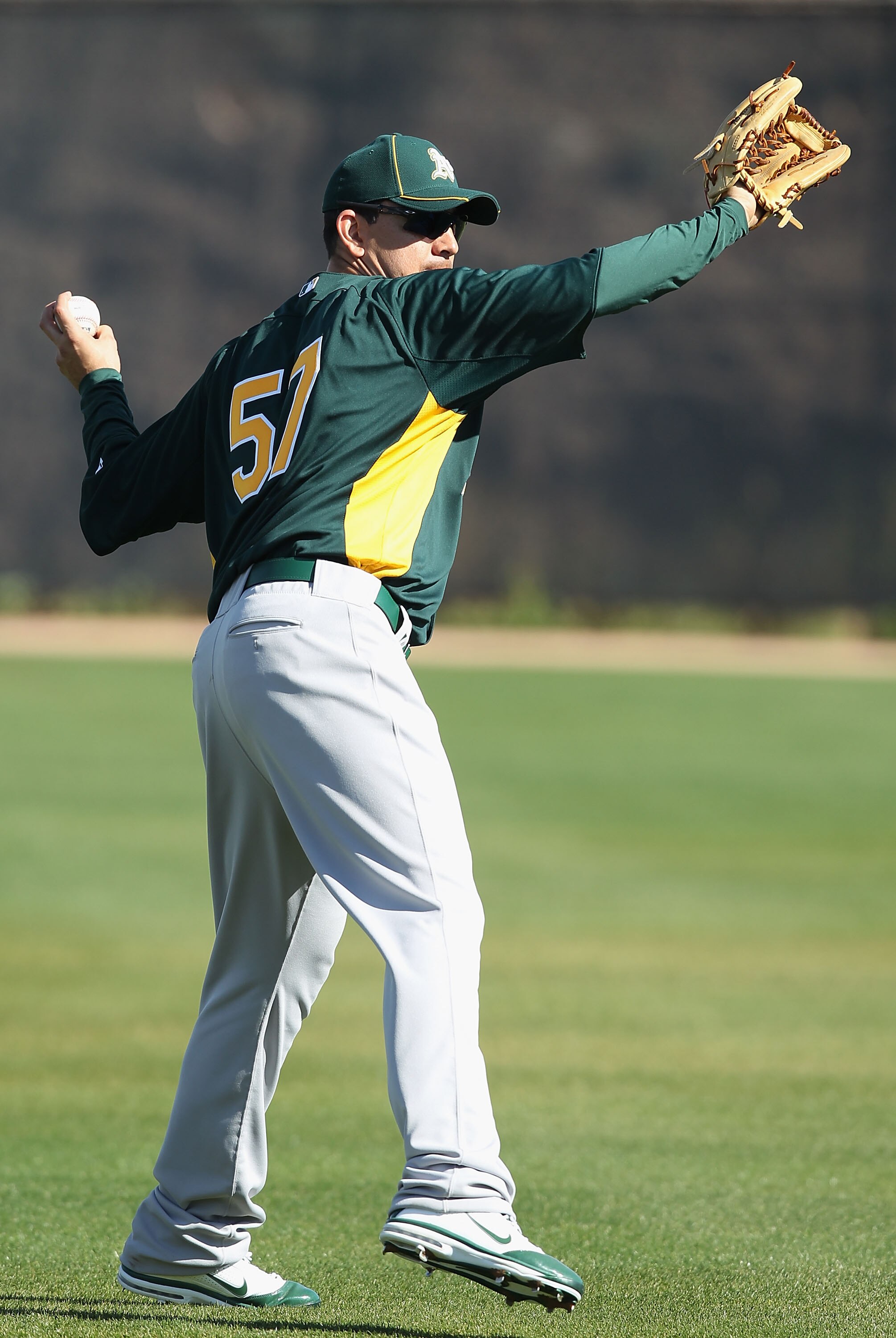 PHOENIX, AZ - FEBRUARY 16:  Pitcher Brian Fuentes #57 of the Oakland Athletics throws during a MLB spring training practice at Phoenix Municipal Stadium on February 16, 2011 in Phoenix, Arizona.  (Photo by Christian Petersen/Getty Images)