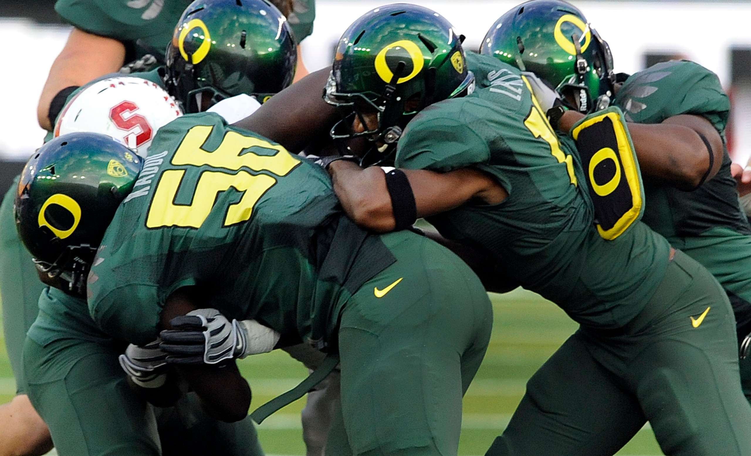EUGENE, OR - OCTOBER 2: Linebacker Josh Kaddu #56 and safety Javes Lewis #14 of the Oregon Ducks team up to tackle running back Stepfan Taylor #33 of the Stanford Cardinal in the second quarter of the game at Autzen Stadium on October 2, 2010 in Eugene, O EUGENE, OR - OCTOBER 2: Linebacker Josh Kaddu #56 and safety Javes Lewis #14 of the Oregon Ducks team up to tackle running back Stepfan Taylor #33 of the Stanford Cardinal in the second quarter of the game at Autzen Stadium on October 2, 2010 in Eugene, O