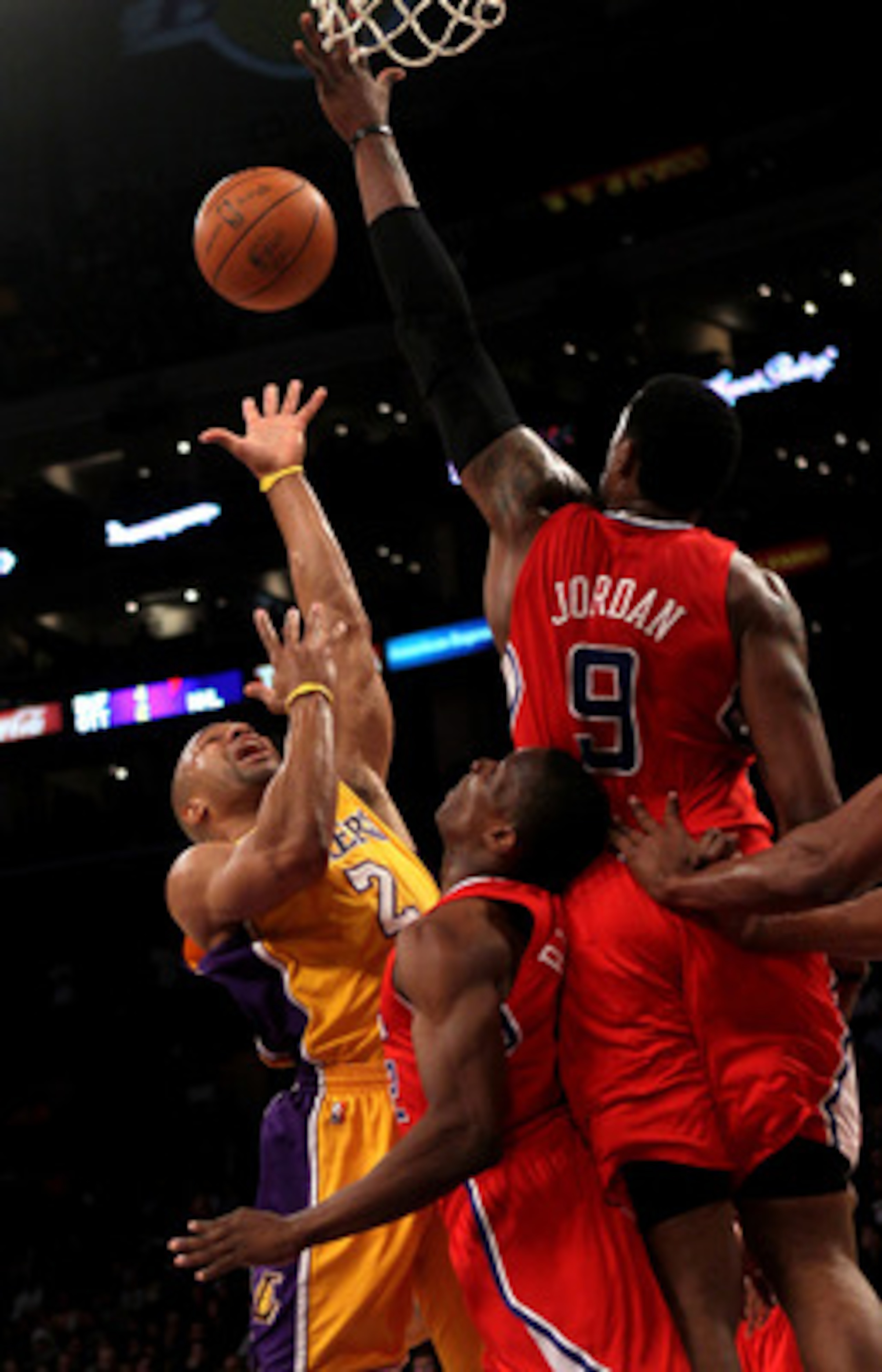 LOS ANGELES, CA - FEBRUARY 25:  Derek Fisher#2 of the Los Angeles Lakers shoots against DeAndre Jordan #9 and Eric Bledsoe #12 of the Los Angeles Clippers at Staples Center on February 25, 2011 in Los Angeles, California. The Lakers won 108-95.  NOTE TO U