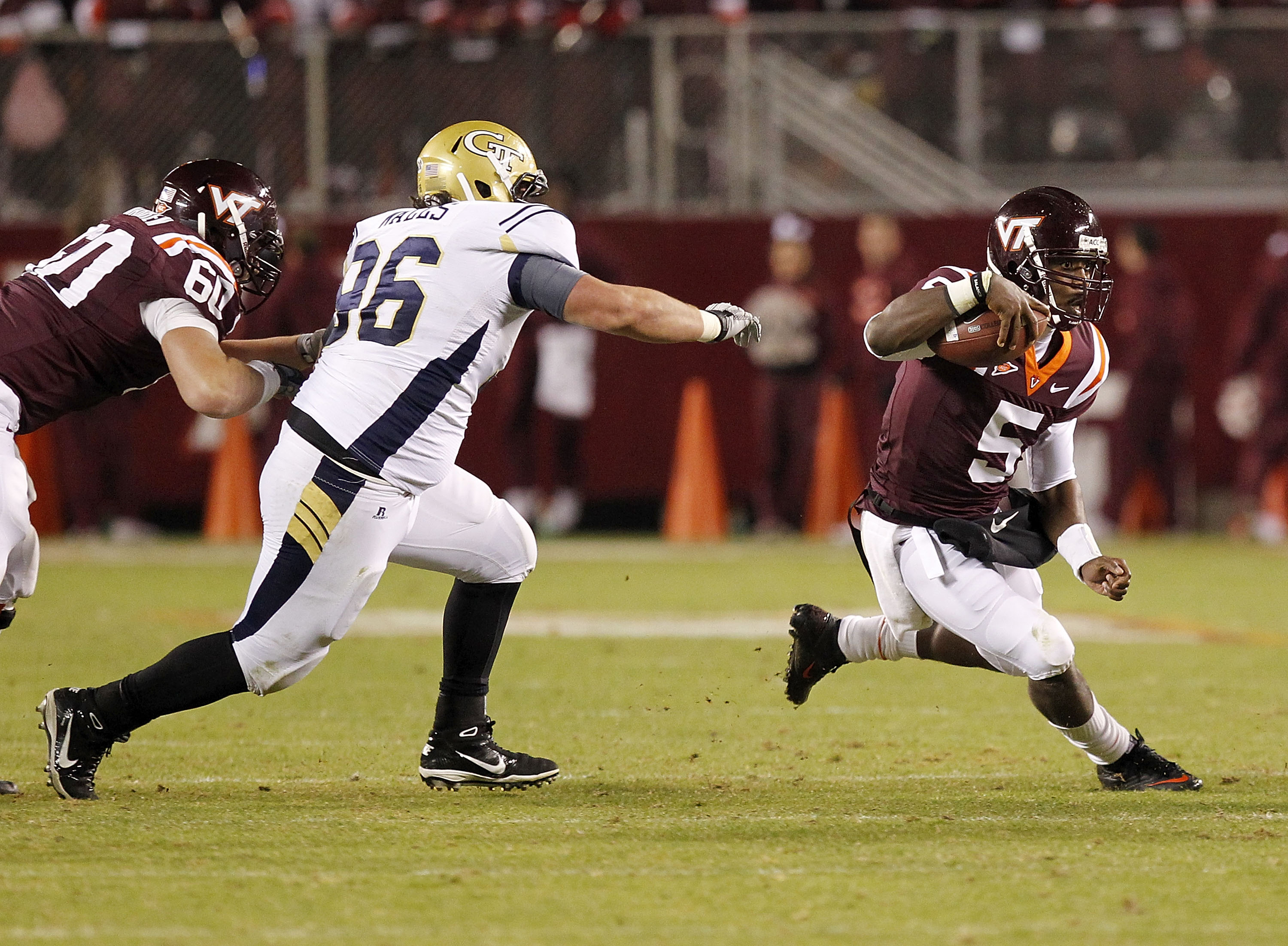 BLACKSBURG, VA - NOVEMBER 04: Quarterback Tyrod Taylor #5 of the Virginia Tech Hokies runs with the ball as defensive tackle Logan Walls #96 of the Georgia Tech Yellow Jackets chases at Lane Stadium on November 4, 2010 in Blacksburg, Virginia.  (Photo by