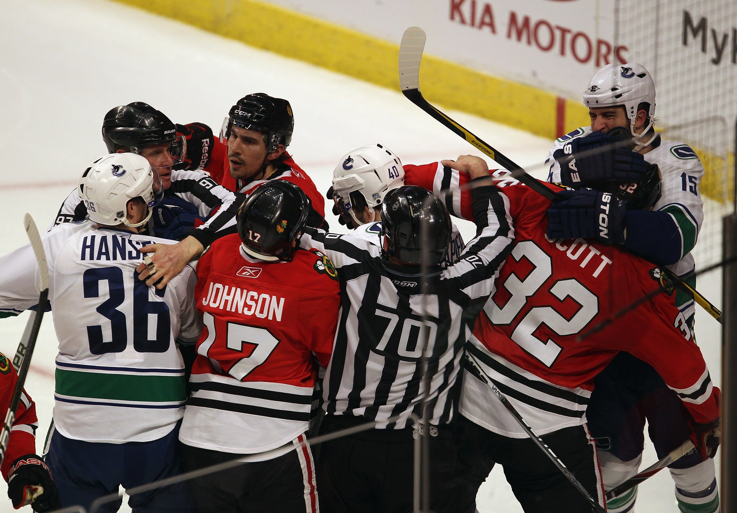 CHICAGO, IL - APRIL 19: Referees try to break up a fight between members of the Chicago Blackhawks including Ryan Johnson #17, Chris Campoli #14 and John Scott #32 with members of the Vancouver Canucks including Jannik Hansen #36, Maxim Lapierre #40 and T CHICAGO, IL - APRIL 19: Referees try to break up a fight between members of the Chicago Blackhawks including Ryan Johnson #17, Chris Campoli #14 and John Scott #32 with members of the Vancouver Canucks including Jannik Hansen #36, Maxim Lapierre #40 and T