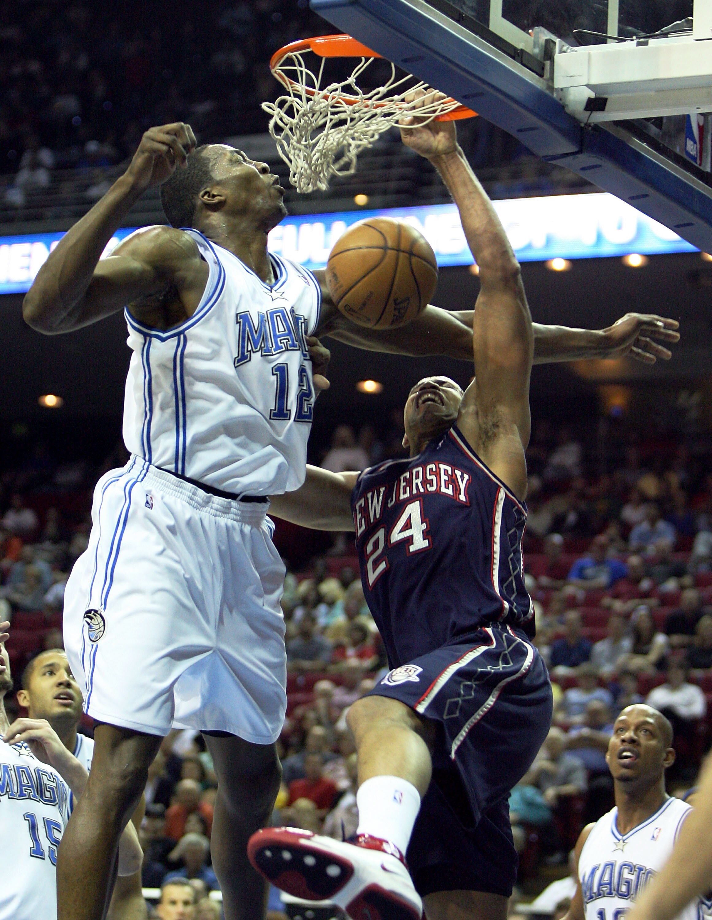 ORLANDO, FL - FEBRUARY 06: Richard Jefferson #24 of the New Jersey Nets is fouled as he dunks on Dwight Howard #12 of the Orlando Magic at Amway Arena on February 6, 2008 in Orlando, Florida. NOTE TO USER: User expressly acknowledges and agrees that, by ORLANDO, FL - FEBRUARY 06: Richard Jefferson #24 of the New Jersey Nets is fouled as he dunks on Dwight Howard #12 of the Orlando Magic at Amway Arena on February 6, 2008 in Orlando, Florida. NOTE TO USER: User expressly acknowledges and agrees that, by