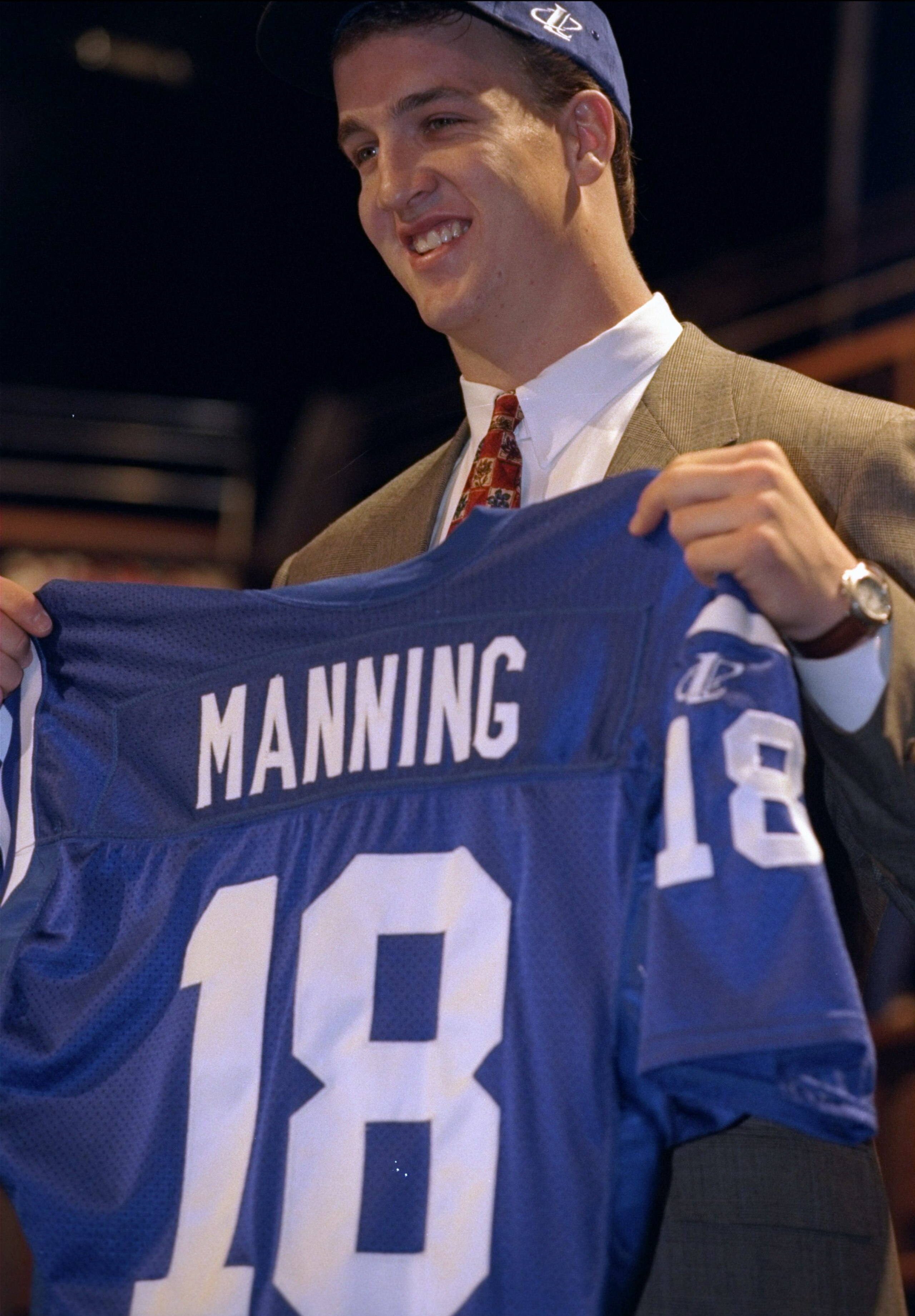 18 Apr 1998: First overall pick Peyton Manning shows off his jersey after being selected by the Indianapolis Colts in the first round of the 1998 NFL Draft at Madison Square Garden in Manhattan, New York. Mandatory Credit: Ezra C. Shaw /Allsport 18 Apr 1998: First overall pick Peyton Manning shows off his jersey after being selected by the Indianapolis Colts in the first round of the 1998 NFL Draft at Madison Square Garden in Manhattan, New York. Mandatory Credit: Ezra C. Shaw /Allsport