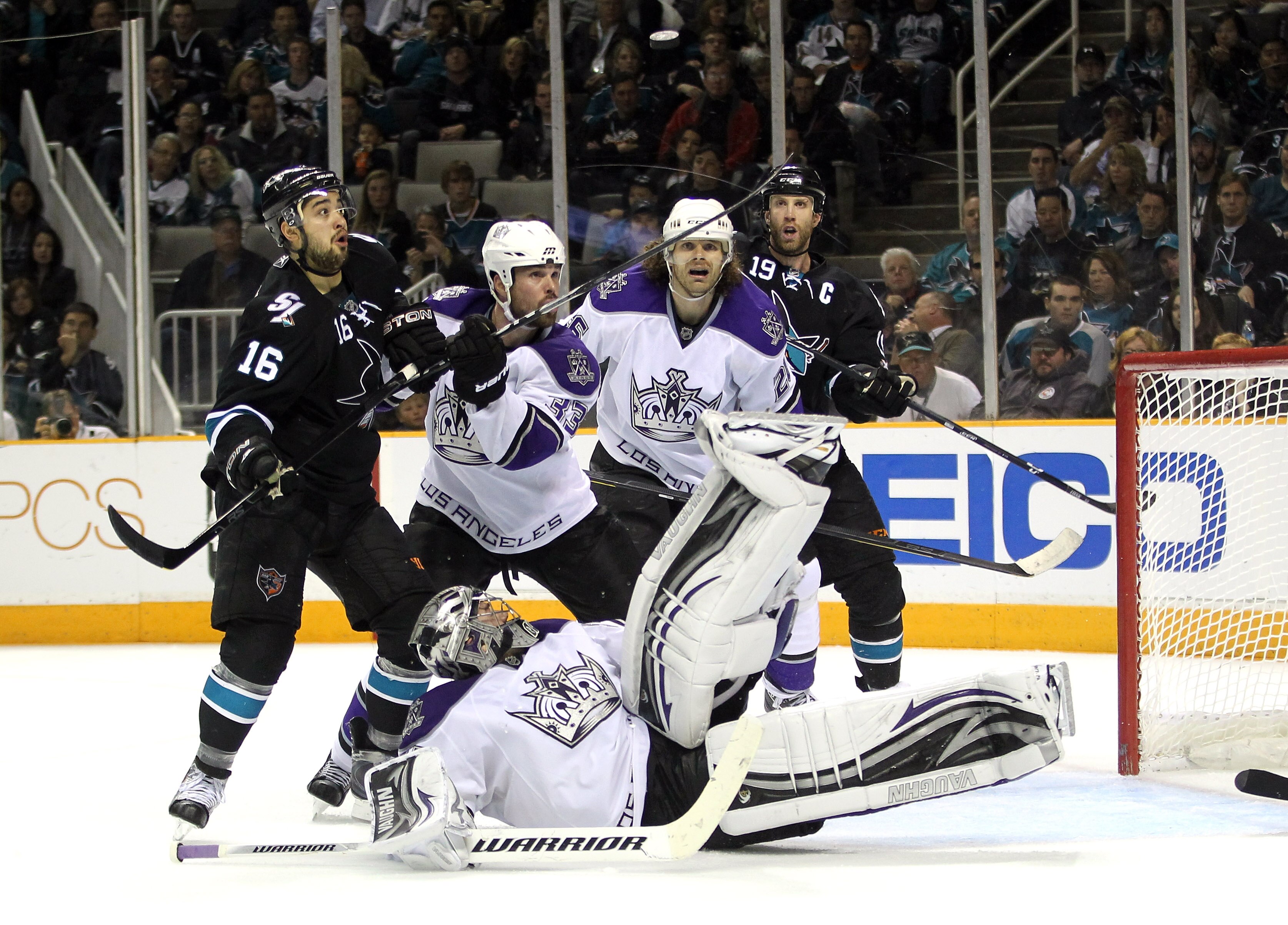 SAN JOSE, CA - APRIL 23:  Willie Mitchell #33 and Michal Handzus #26 of the Los Angeles Kings and Devin Setoguchi #16 and Joe Thornton #19 of the San Jose Sharks look on against the San Jose Sharks Jonathan Quick #32 of the Los Angeles Kings makes a divin