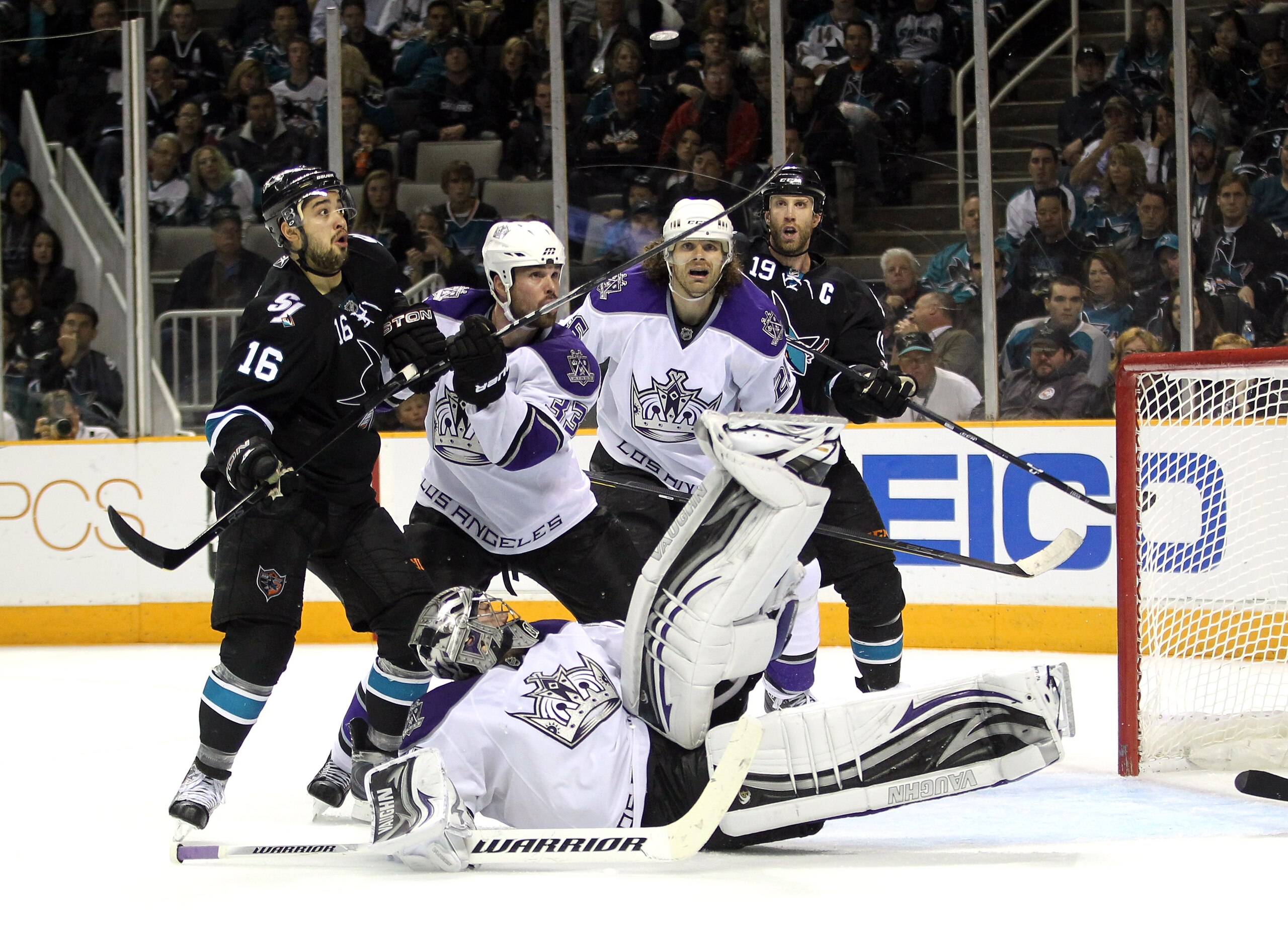 SAN JOSE, CA - APRIL 23:  Willie Mitchell #33 and Michal Handzus #26 of the Los Angeles Kings and Devin Setoguchi #16 and Joe Thornton #19 of the San Jose Sharks look on against the San Jose Sharks Jonathan Quick #32 of the Los Angeles Kings makes a divin