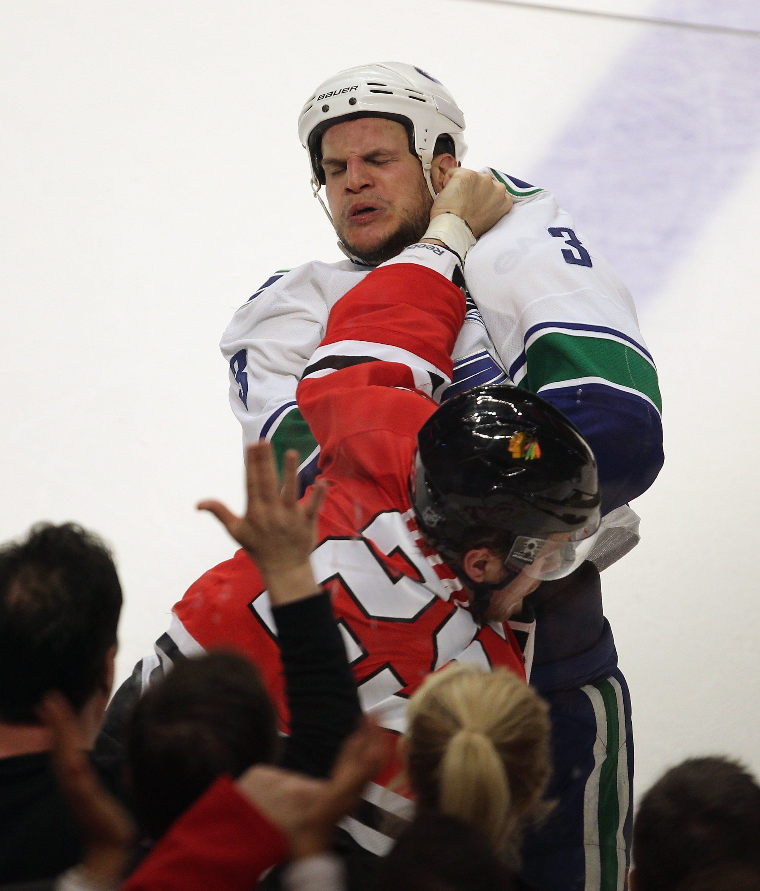 CHICAGO, IL - APRIL 19: Viktor Stalberg #25 of the Chicago Blackhawks fights with Kevin Bieksa #3 of the Vancouver Canucks in Game Four of the Western Conference Quarterfinals during the 2011 NHL Stanley Cup Playoffs at the United Center on April 19, 2011
