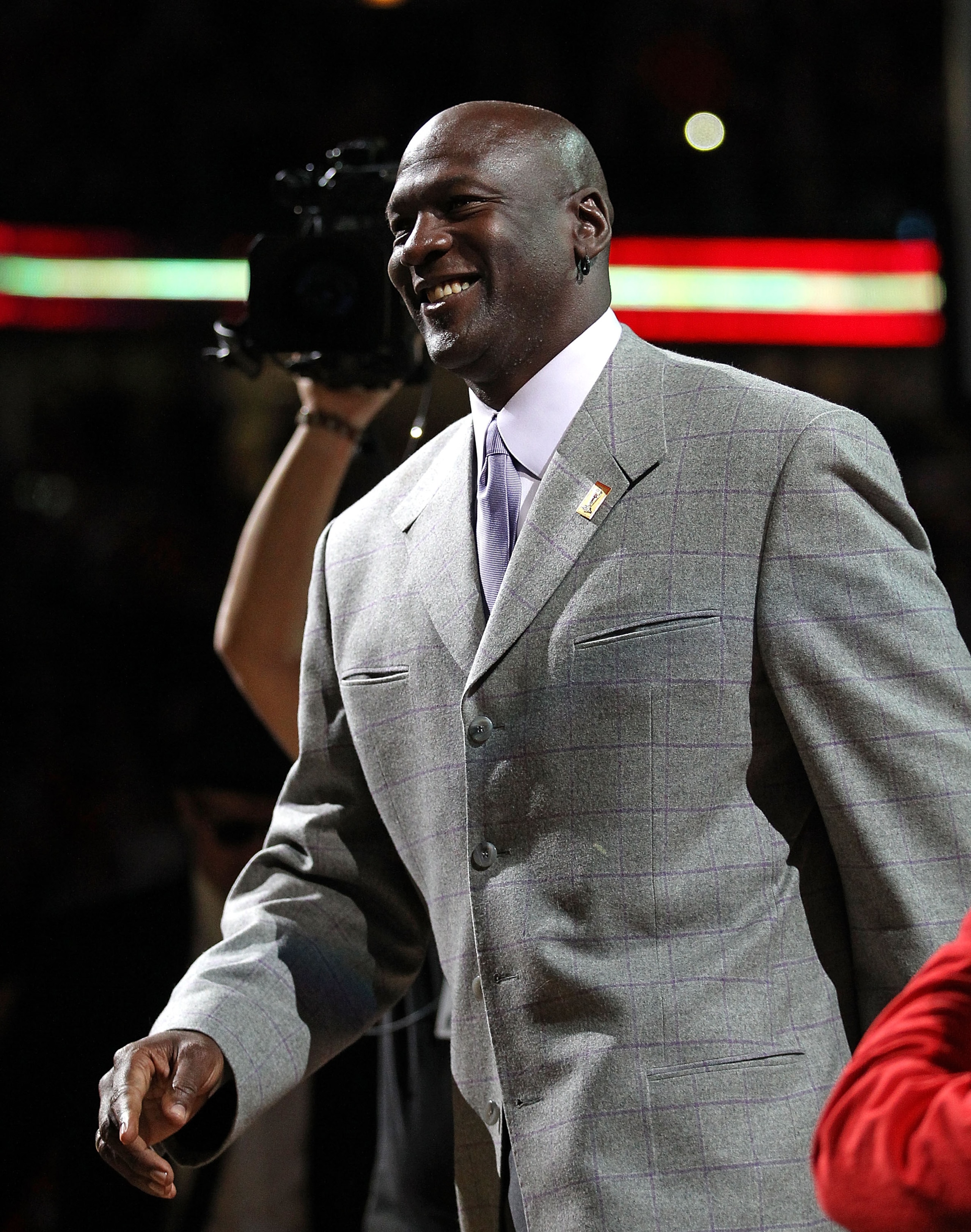 CHICAGO, IL - MARCH 12: Former player Michael Jordan of the Chicago Bulls smiles as he is introduced to the crowd during a 20th anniversary recognition ceremony of the Bulls 1st NBA Championship in 1991 during half-time of a game bewteen the Bulls and th CHICAGO, IL - MARCH 12: Former player Michael Jordan of the Chicago Bulls smiles as he is introduced to the crowd during a 20th anniversary recognition ceremony of the Bulls 1st NBA Championship in 1991 during half-time of a game bewteen the Bulls and th