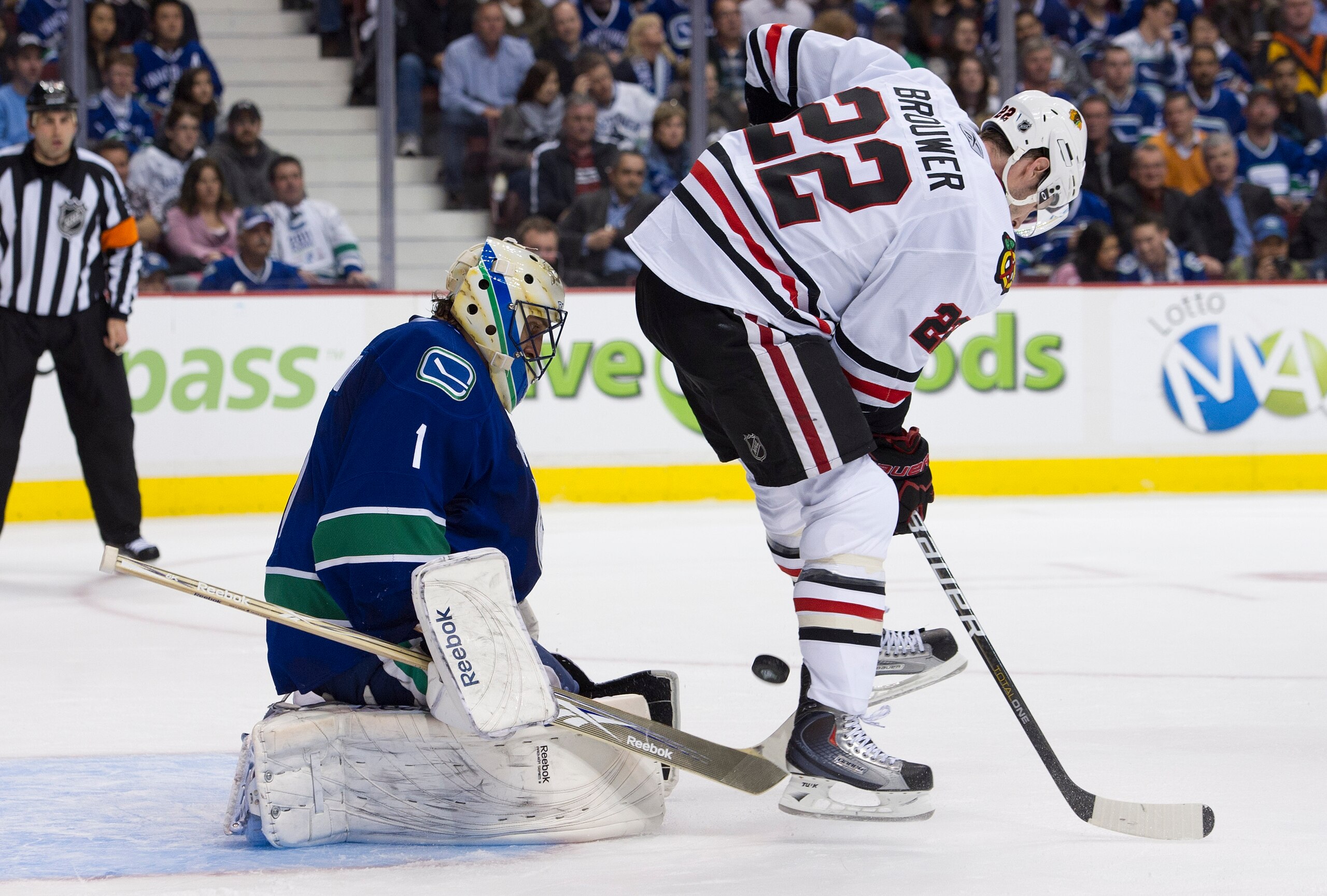 VANCOUVER, CANADA - APRIL 13: Troy Brouwer #22 of the Chicago Blackhawks tries to deflect the puck past goalie Roberto Luongo #1 of the Vancouver Canucks during the second period in Game One of the Western Conference Quarterfinals during the 2011 NHL Stan