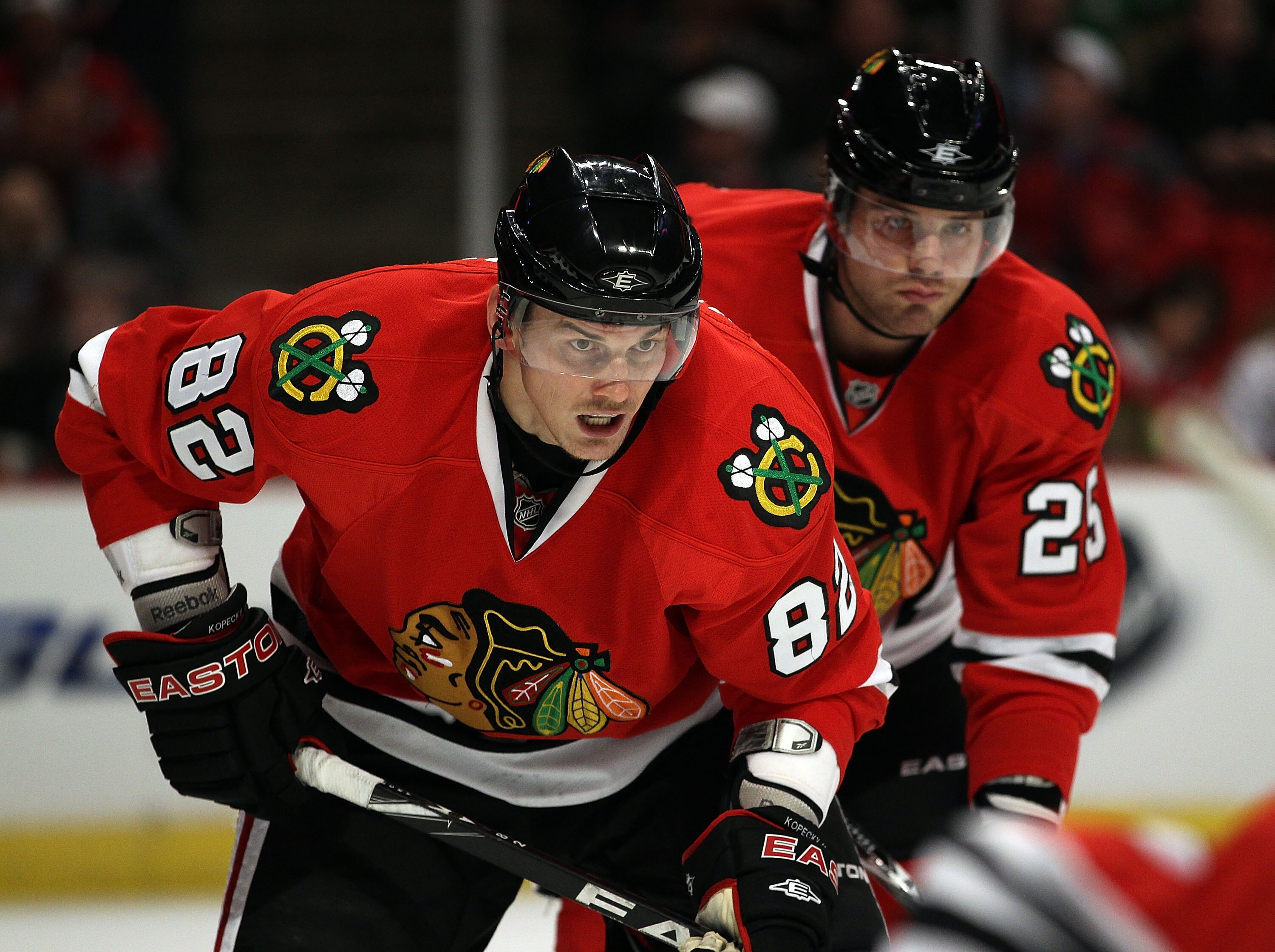 CHICAGO, IL - MARCH 02: Tomas Kopecky #82 and Viktor Stalberg #25 of the Chicago Blackhawks await a face-off against the Calgary Flames at the United Center on March 2, 2011 in Chicago, Illinois. The Blackhawks defeated the Flames 6-4. (Photo by Jonathan