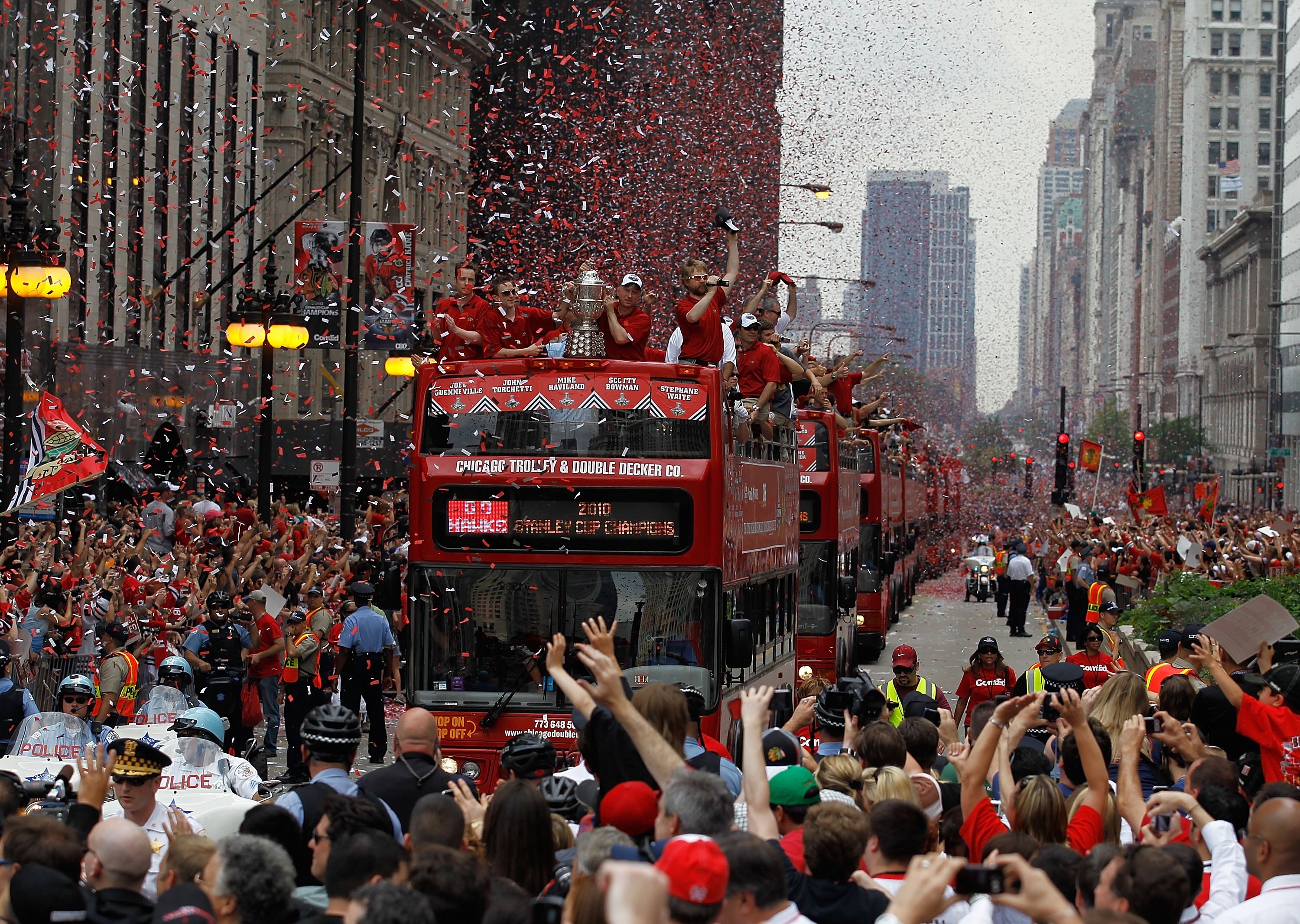 CHICAGO - JUNE 11: Buses carrying members of the Chicago Blackhawks players, staff and families make their way down Michigan Avenue during the Chicago Blackhawks Stanley Cup victory parade and rally on June 11, 2010 in Chicago, Illinois. (Photo by Jonatha
