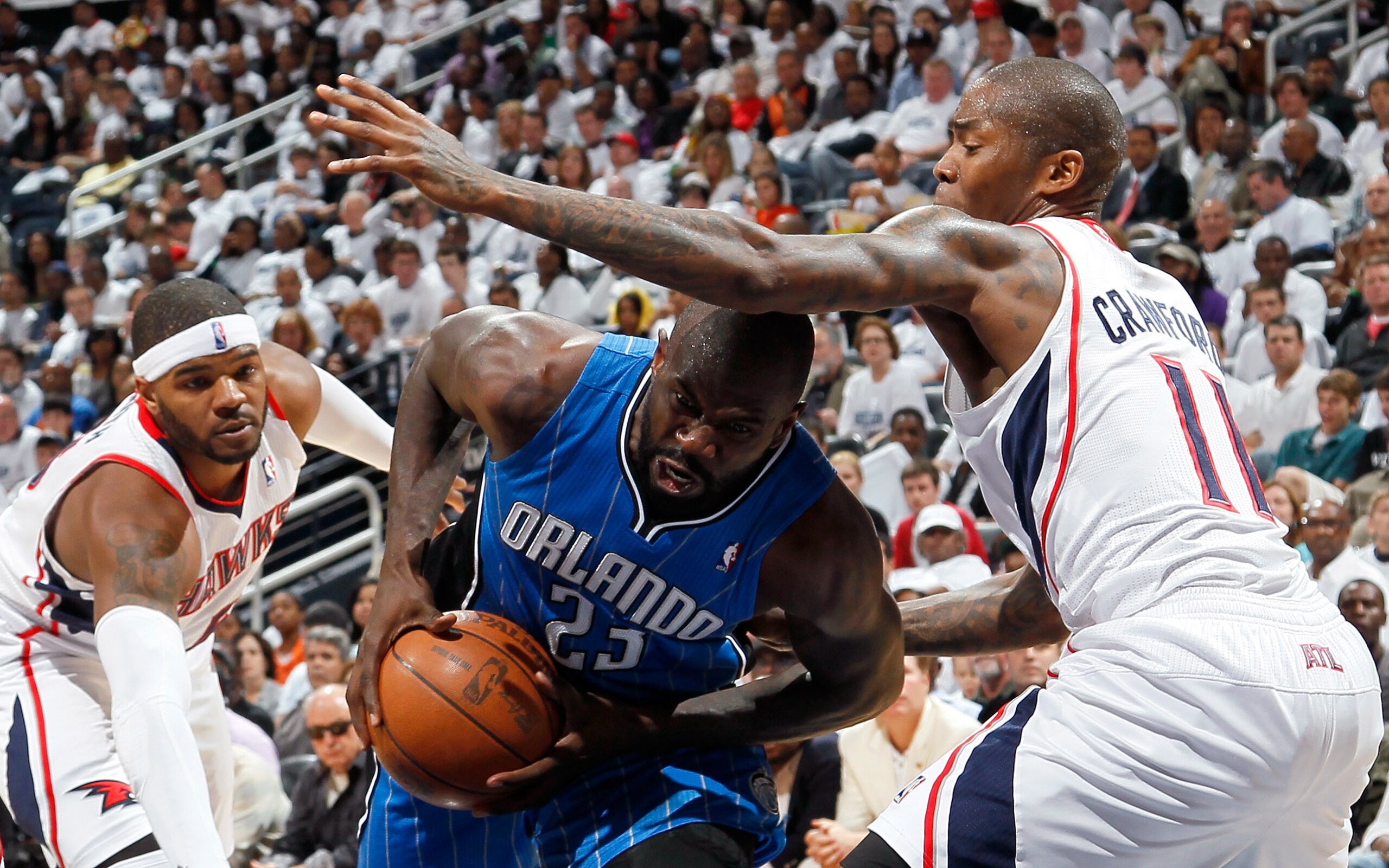 ATLANTA, GA - APRIL 22:  Jason Richardson #23 of the Orlando Magic drives between Josh Smith #5 and Jamal Crawford #11 of the Atlanta Hawks during Game Three of the Eastern Conference Quarterfinals in the 2011 NBA Playoffs at Philips Arena on April 22, 20