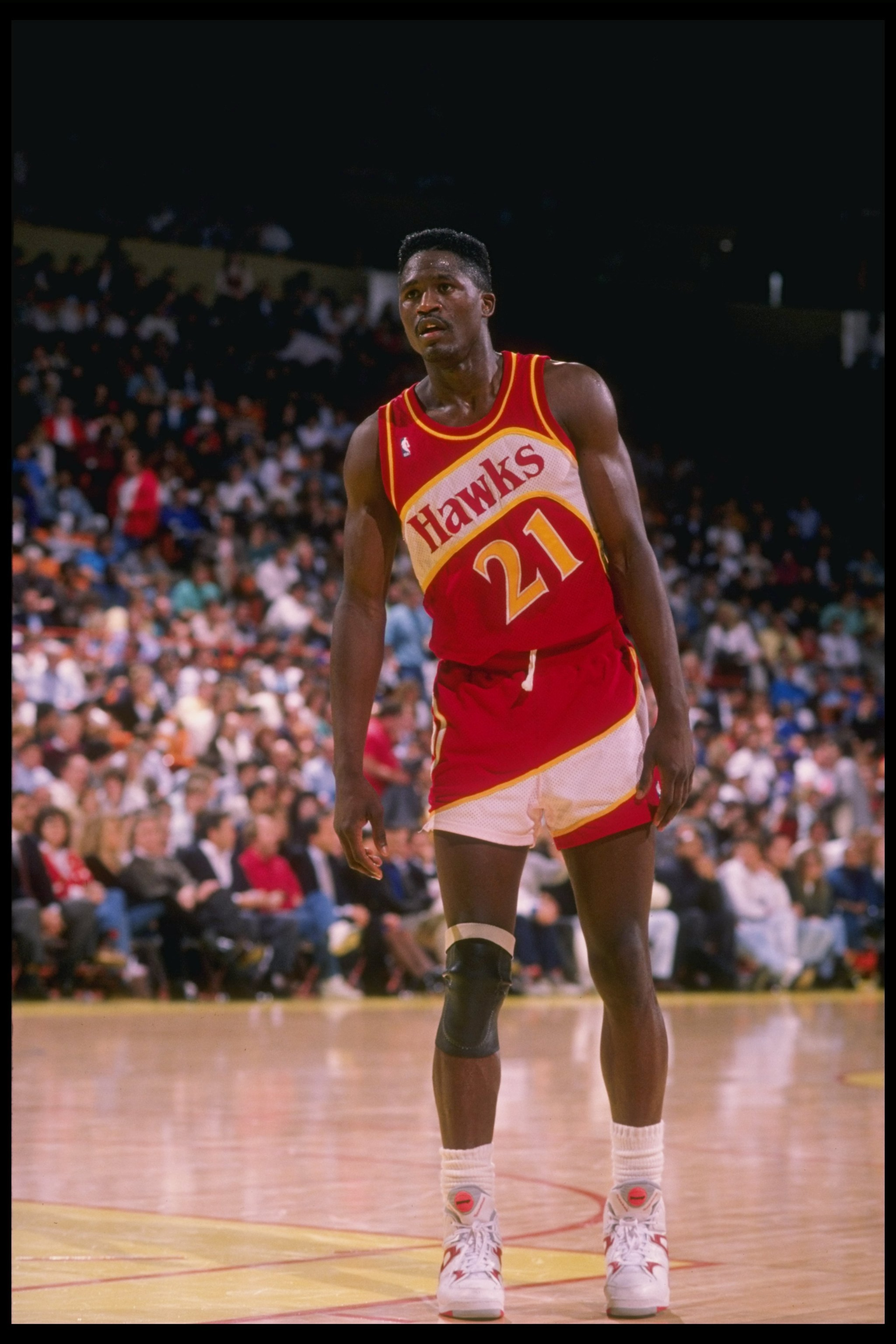 Forward Dominique Wilkins of the Atlanta Hawks stands on the court during a game. Forward Dominique Wilkins of the Atlanta Hawks stands on the court during a game.
