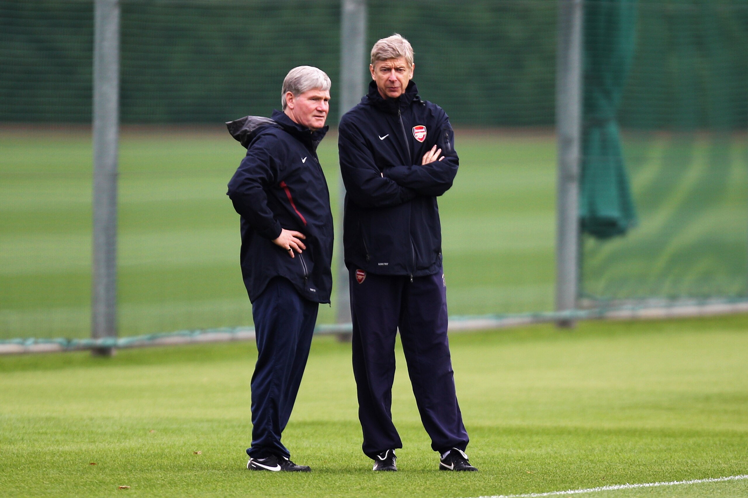 ST ALBANS, ENGLAND - OCTOBER 18:  Arsenal Manager, Arsene Wenger (R) and Assistant manager Pat Rice speak during a training session ahead of the UEFA Champions League game against Shakhtar Donetsk at the club's complex at London Colney on October 18, 2010