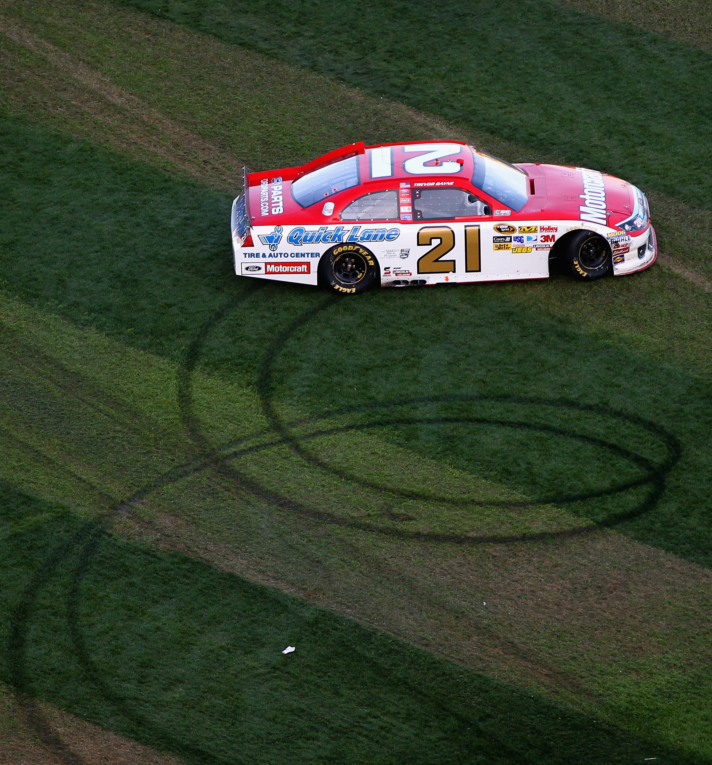 DAYTONA BEACH, FL - FEBRUARY 20:  Trevor Bayne, driver of the #21 Motorcraft/Quicklane Ford, performs a burnout in front of the crowd after winning the NASCAR Sprint Cup Series Daytona 500 at Daytona International Speedway on February 20, 2011 in Daytona