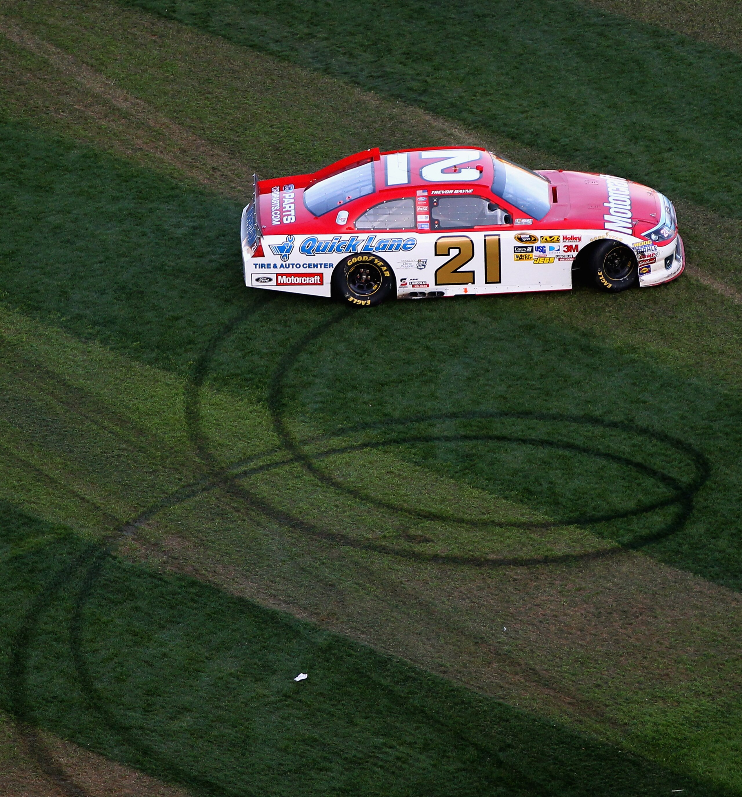 DAYTONA BEACH, FL - FEBRUARY 20:  Trevor Bayne, driver of the #21 Motorcraft/Quicklane Ford, performs a burnout in front of the crowd after winning the NASCAR Sprint Cup Series Daytona 500 at Daytona International Speedway on February 20, 2011 in Daytona