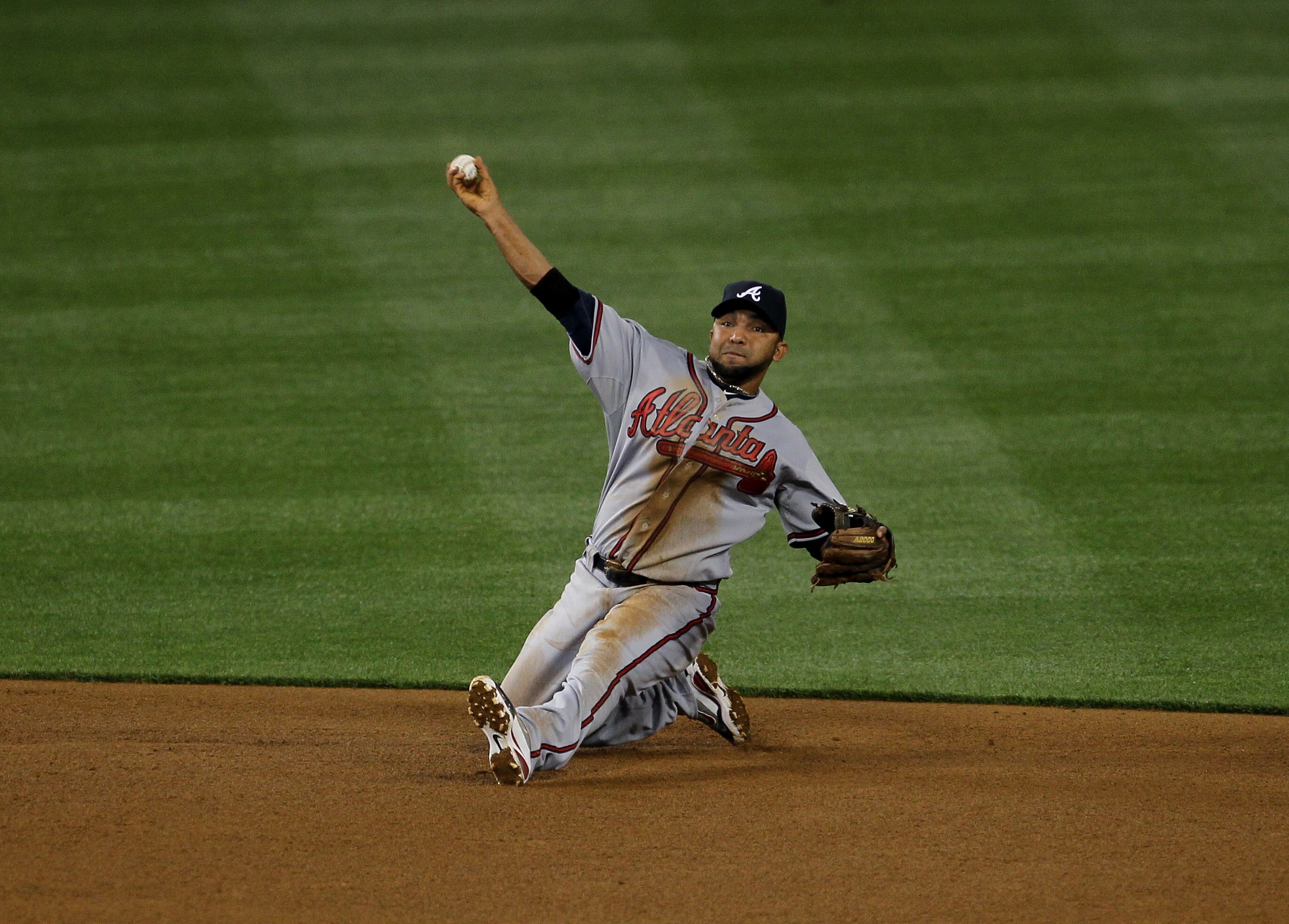 LOS ANGELES - APRIL 18: Shortstop Alex Gonzalez #2 of the Atlanta Braves throws out Rod Barajas of the Los Angeles Dodgers after making a diving stop to end the third inning on April 18, 2011 at Dodger Stadium in Los Angeles, California.   (Photo by Steph