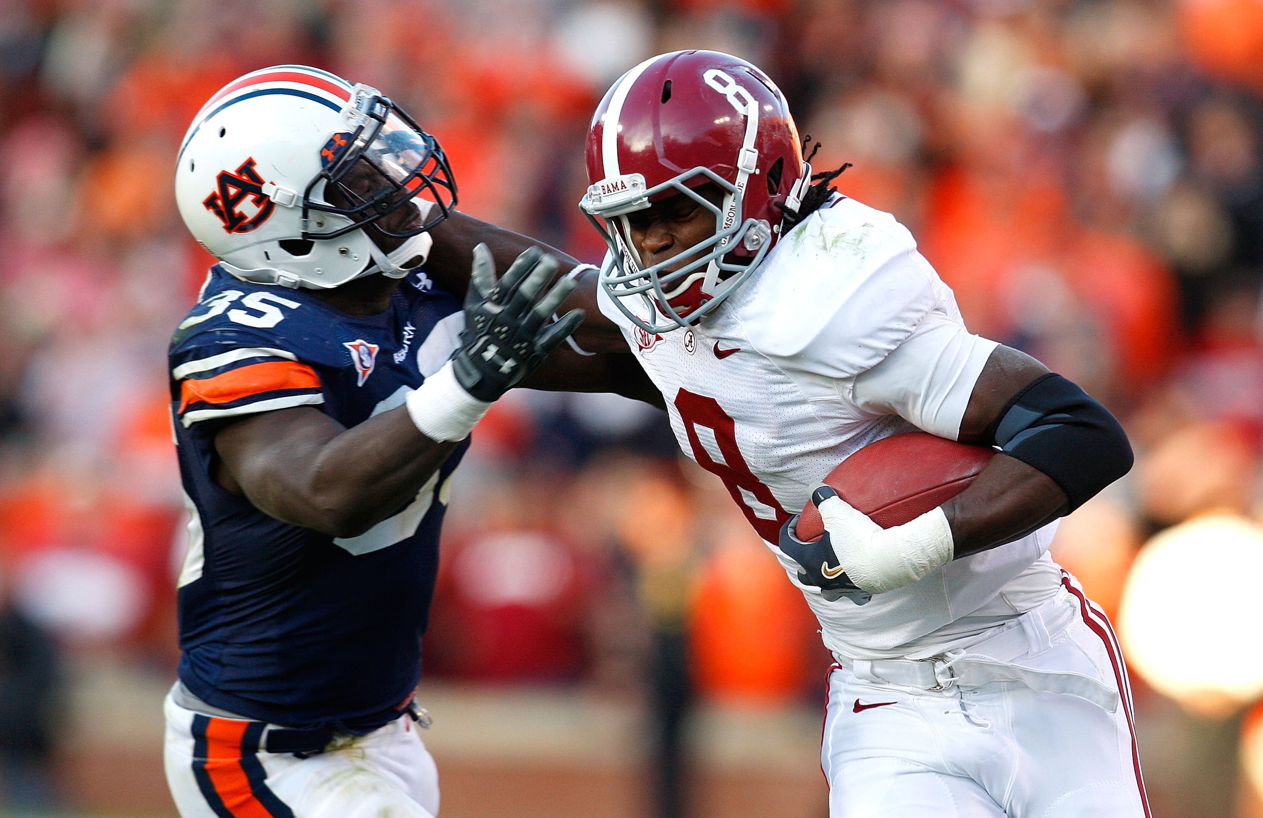 AUBURN, AL - NOVEMBER 27: Julio Jones #8 of the Alabama Crimson Tide tries to break a tackle by Jonathan Evans #35 of the Auburn Tigers at Jordan-Hare Stadium on November 27, 2009 in Auburn, Alabama. (Photo by Kevin C. Cox/Getty Images) AUBURN, AL - NOVEMBER 27: Julio Jones #8 of the Alabama Crimson Tide tries to break a tackle by Jonathan Evans #35 of the Auburn Tigers at Jordan-Hare Stadium on November 27, 2009 in Auburn, Alabama. (Photo by Kevin C. Cox/Getty Images)