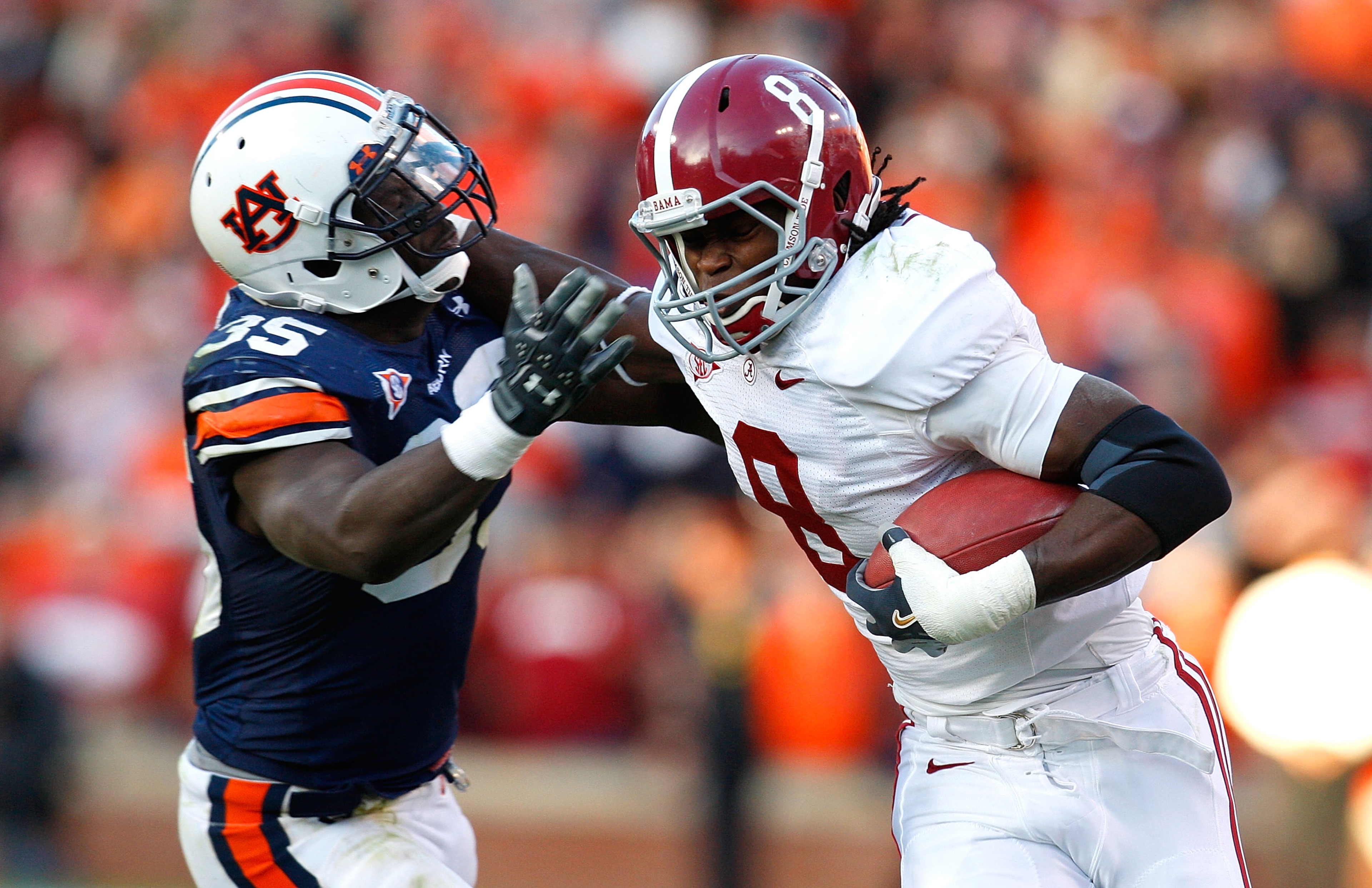 AUBURN, AL - NOVEMBER 27:  Julio Jones #8 of the Alabama Crimson Tide tries to break a tackle by Jonathan Evans #35 of the Auburn Tigers at Jordan-Hare Stadium on November 27, 2009 in Auburn, Alabama.  (Photo by Kevin C. Cox/Getty Images)