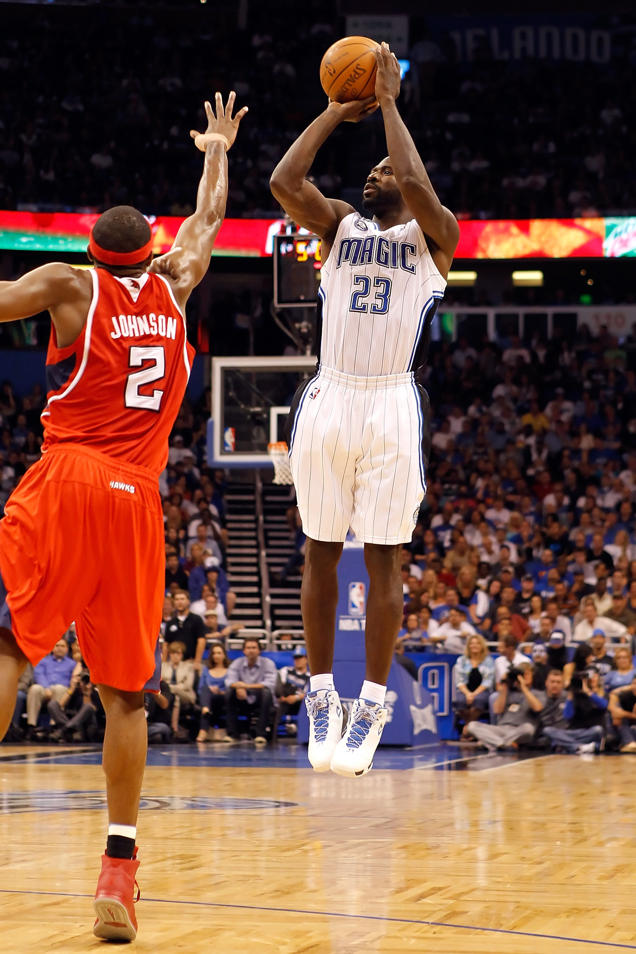 ORLANDO, FL - APRIL 19:  Jason Richardson #23 of the Orlando Magic shoots over Joe Johnson #2 of the Atlanta Hawks of the Orlando Magic during Game Two of the Eastern Conference Quarterfinals of the 2011 NBA Playoffs on April 19, 2011 at the Amway Arena i