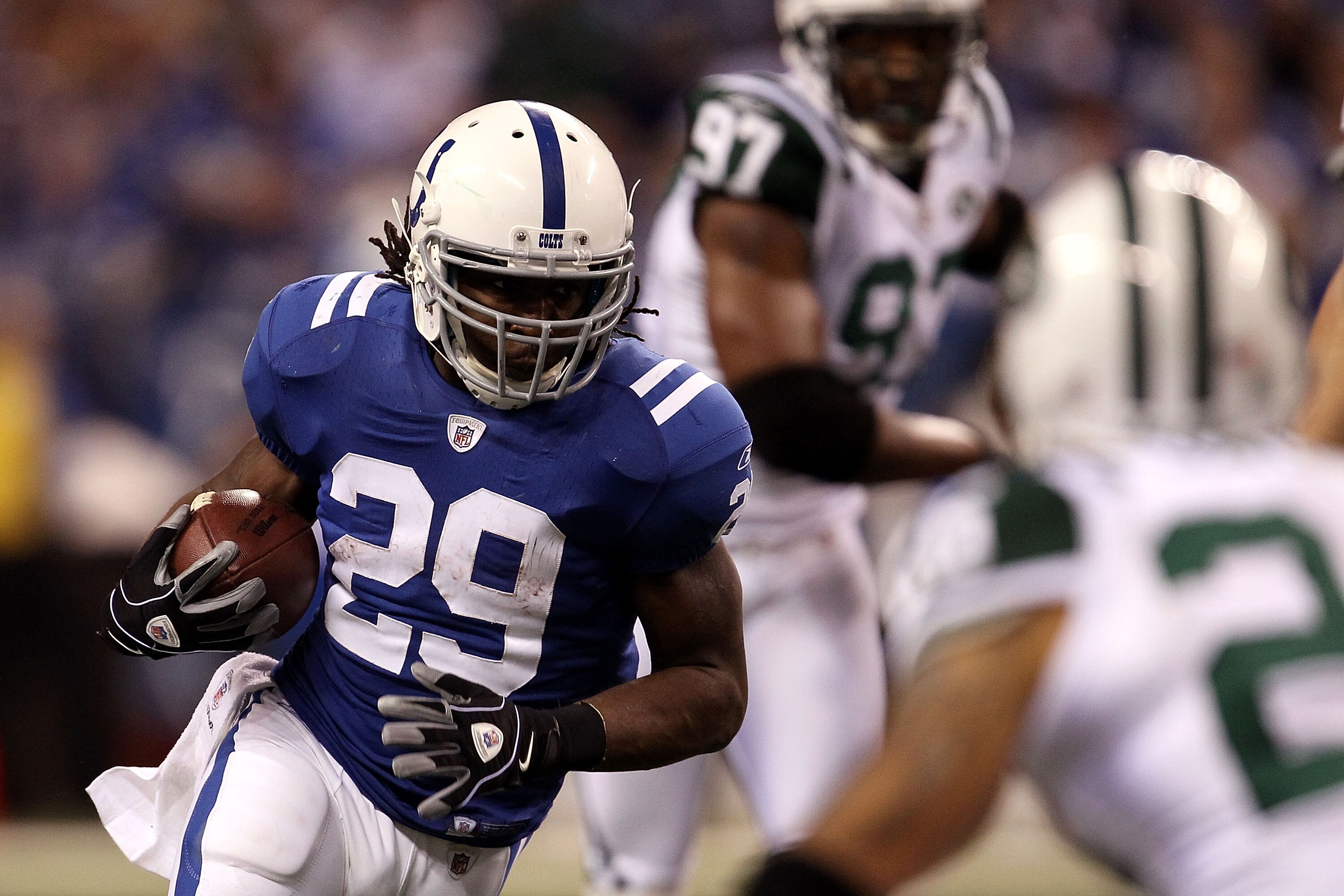 INDIANAPOLIS, IN - JANUARY 08:  Joseph Addai #29 of the Indianapolis Colts runs the ball against the New York Jets during their 2011 AFC wild card playoff game at Lucas Oil Stadium on January 8, 2011 in Indianapolis, Indiana.  The Jets won 17-16. (Photo b