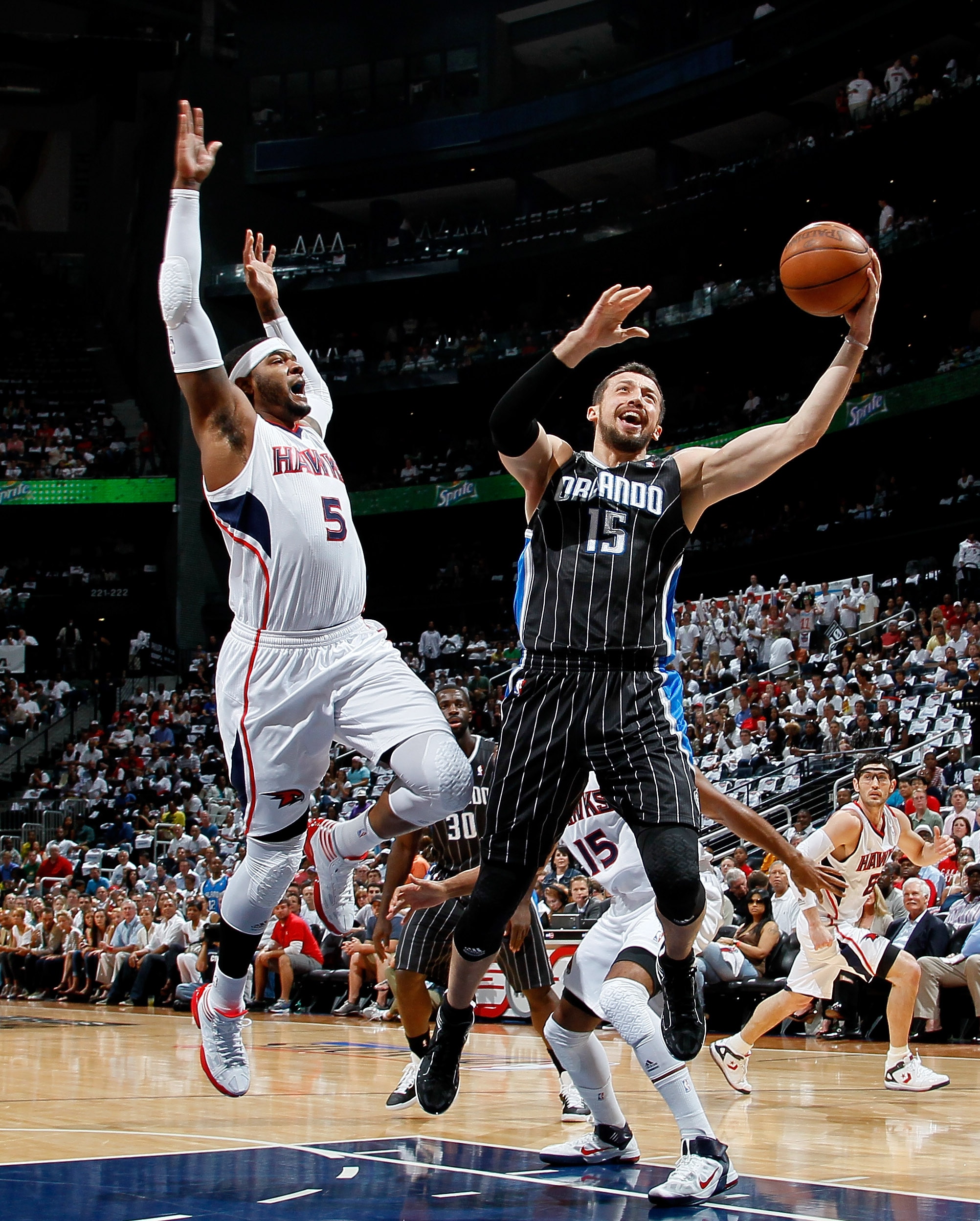 ATLANTA, GA - APRIL 24:  Hedo Turkoglu #15 of the Orlando Magic drives the basket against Josh Smith #5 of the Atlanta Hawks during Game Four of the Eastern Conference Quarterfinals in the 2011 NBA Playoffs at Philips Arena on April 24, 2011 in Atlanta, G