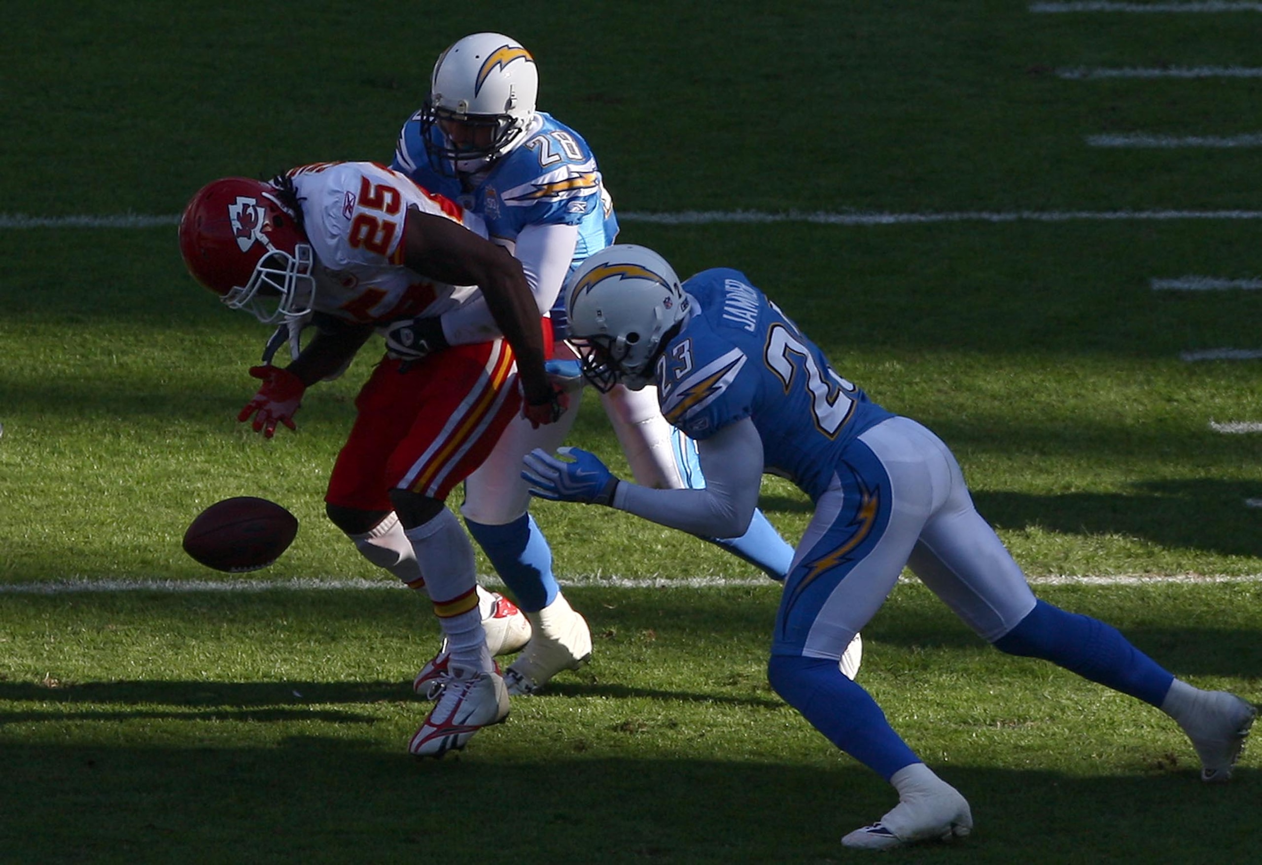 SAN DIEGO, CA - NOVEMBER 29:   Steve Gregory #28 and Quentin Jammer #23 of the San Diego Chargers forces a fumble by Runningback Jamaal Charles #25 of the Kansas City Chiefs during the NFL game on November 29, 2009 at Qualcomm Stadium in San Diego, Califo