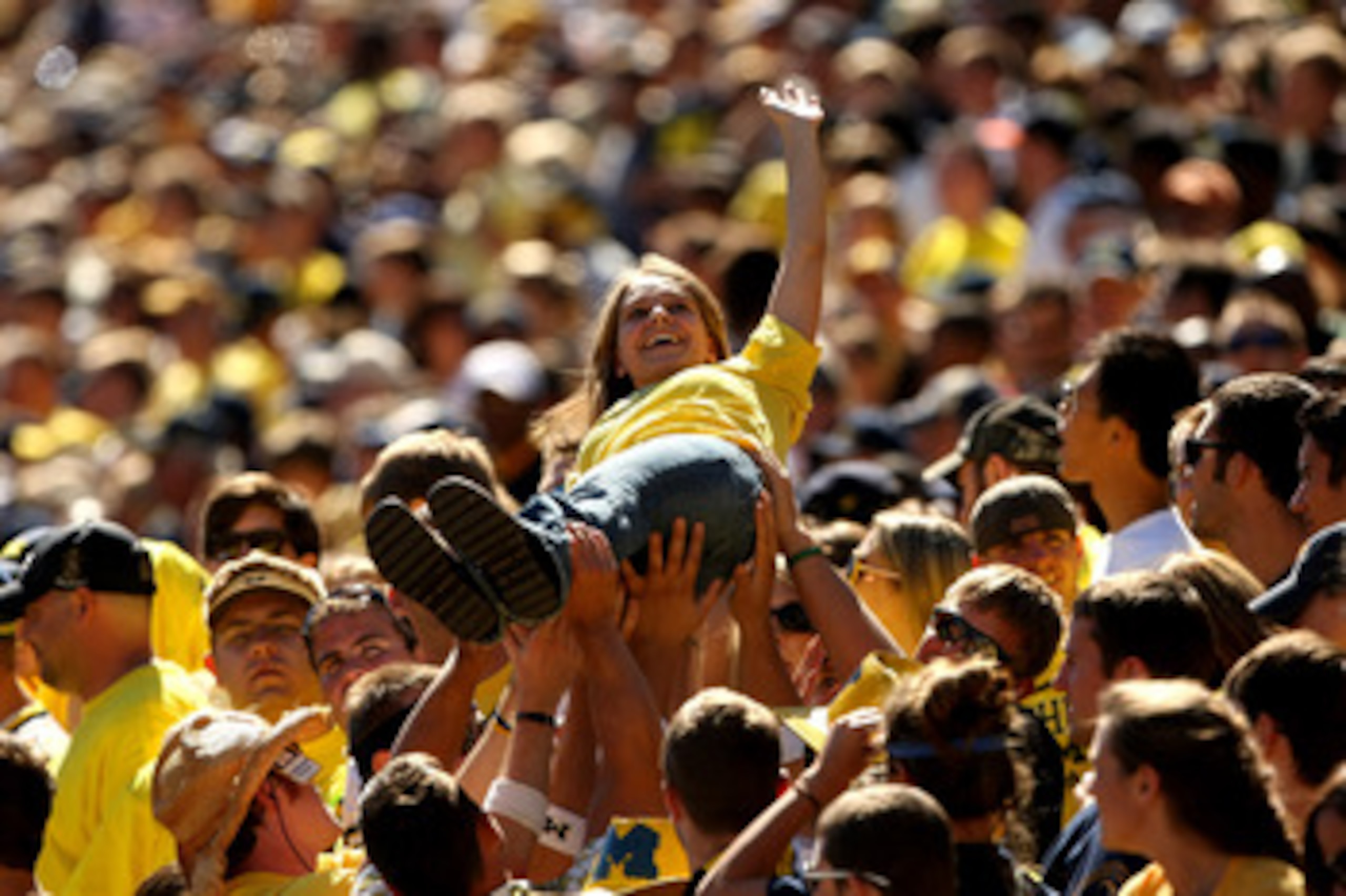 ANN ARBOR, MI - SEPTEMBER 19: Members of the Michigan Wolverines student section lift a fan to celebrate a score against the Eastern Michigan Eagles at Michigan Stadium on September 19, 2009 in Ann Arbor, Michigan. Michigan won 45-17.  (Photo by Stephen D