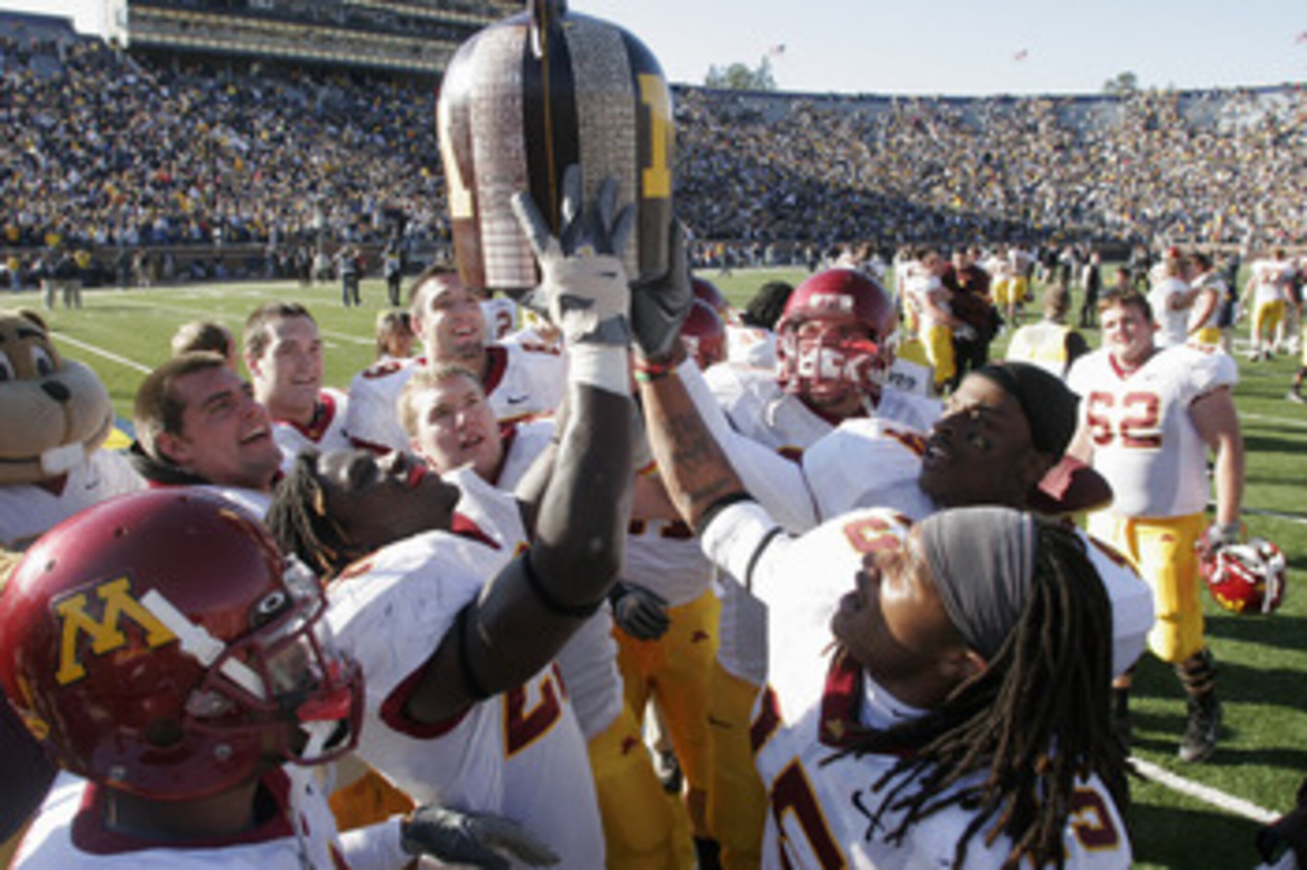 ANN ARBOR - OCTOBER 8:  The Minnesota Gophers celebrate their win after the game against the Michigan Wolverines at Michigan Stadium on October 8, 2005 in Ann Arbor, Michigan.  The pass was incomplete. Minnesota won 23-20. (Photo by Tom Pidgeon/Getty Imag