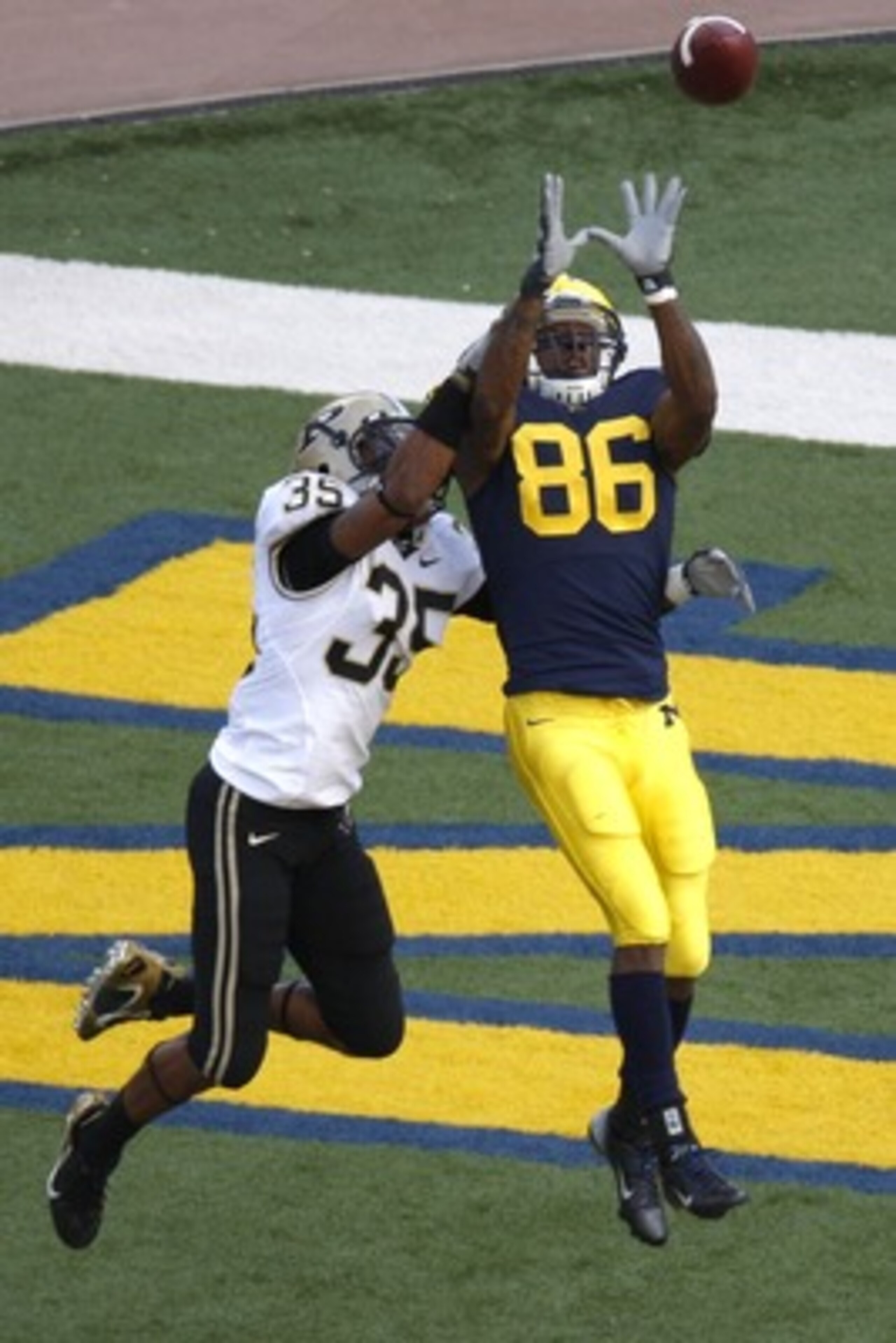 ANN ARBOR, MI - OCTOBER 13: Mario Manningham #86 of the Michigan Wolverines catches a second quarter touchdown pass in front of David Pender #35 of the Purdue Boilermakers on October 13, 2007 at Michigan Stadium in Ann Arbor, Michigan. (Photo By Gregory S
