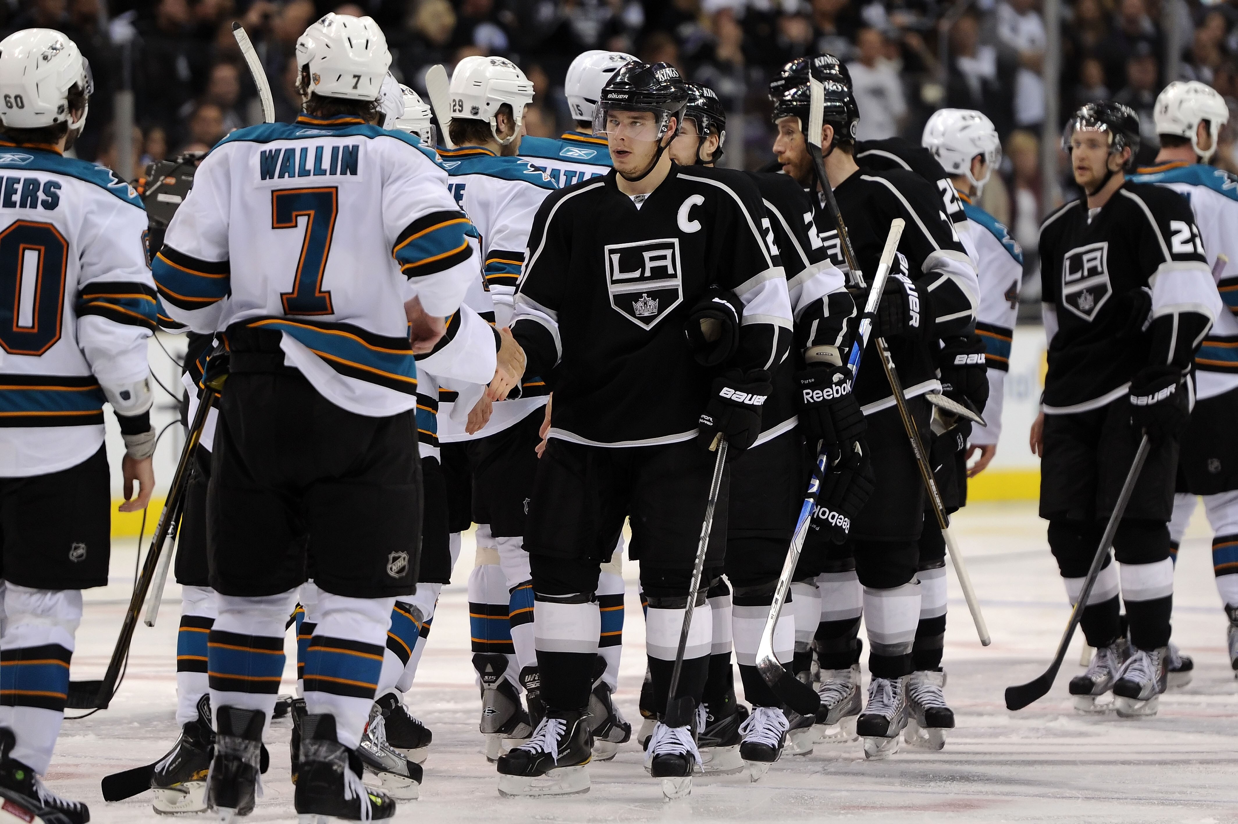 LOS ANGELES, CA - APRIL 25:  Dustin Brown #23 of the Los Angeles Kings shakes hands with the San Jose Sharks after being eliminated in game six of the Western Conference Quarterfinals during the 2011 NHL Stanley Cup Playoffs at Staples Center on April 25,