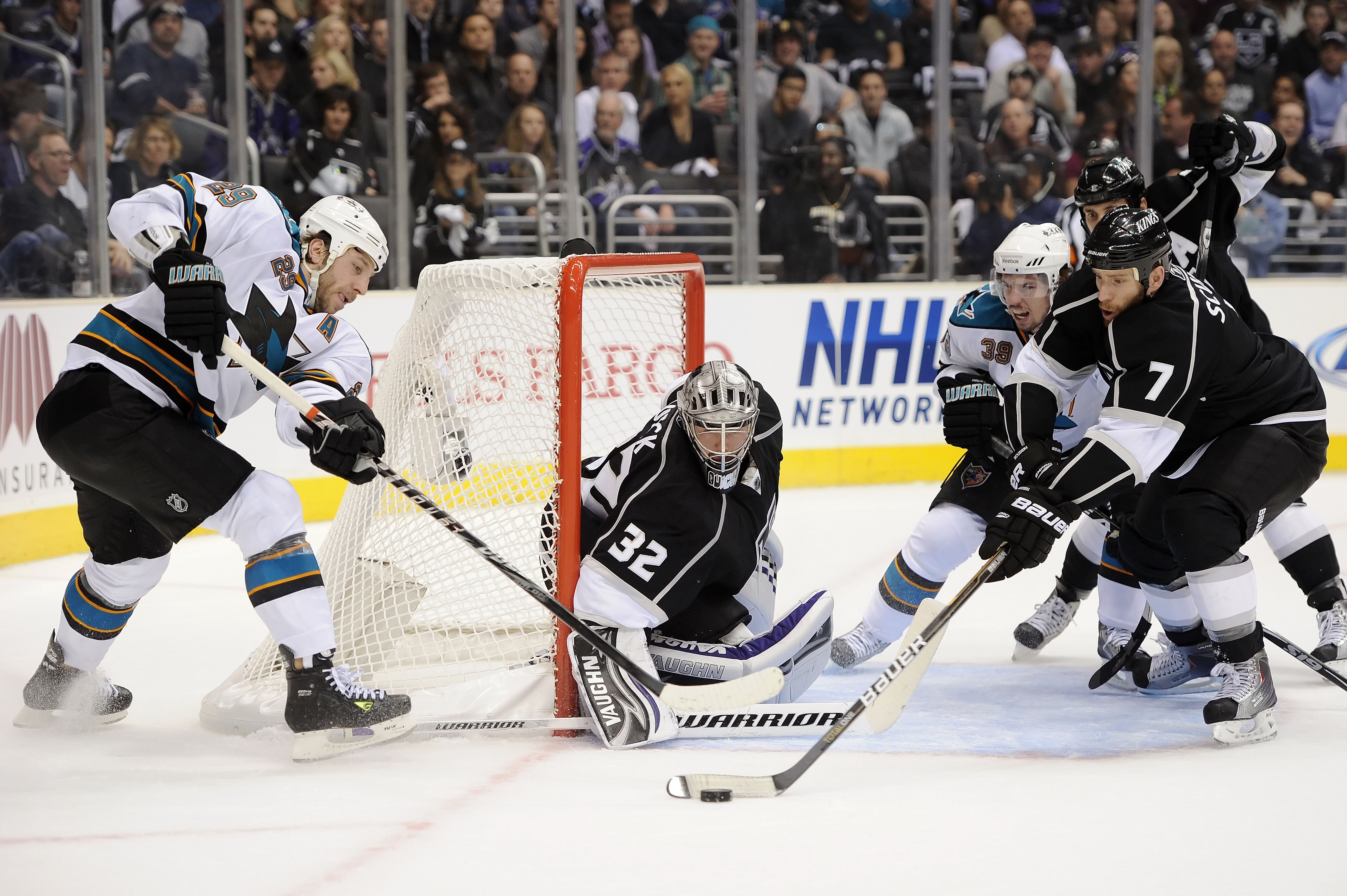 LOS ANGELES, CA - APRIL 25:  Rob Scuderi #7 of the Los Angeles Kings clears the puck from in front of the net in game six of the Western Conference Quarterfinals against the San Jose Sharks during the 2011 NHL Stanley Cup Playoffs at Staples Center on Apr